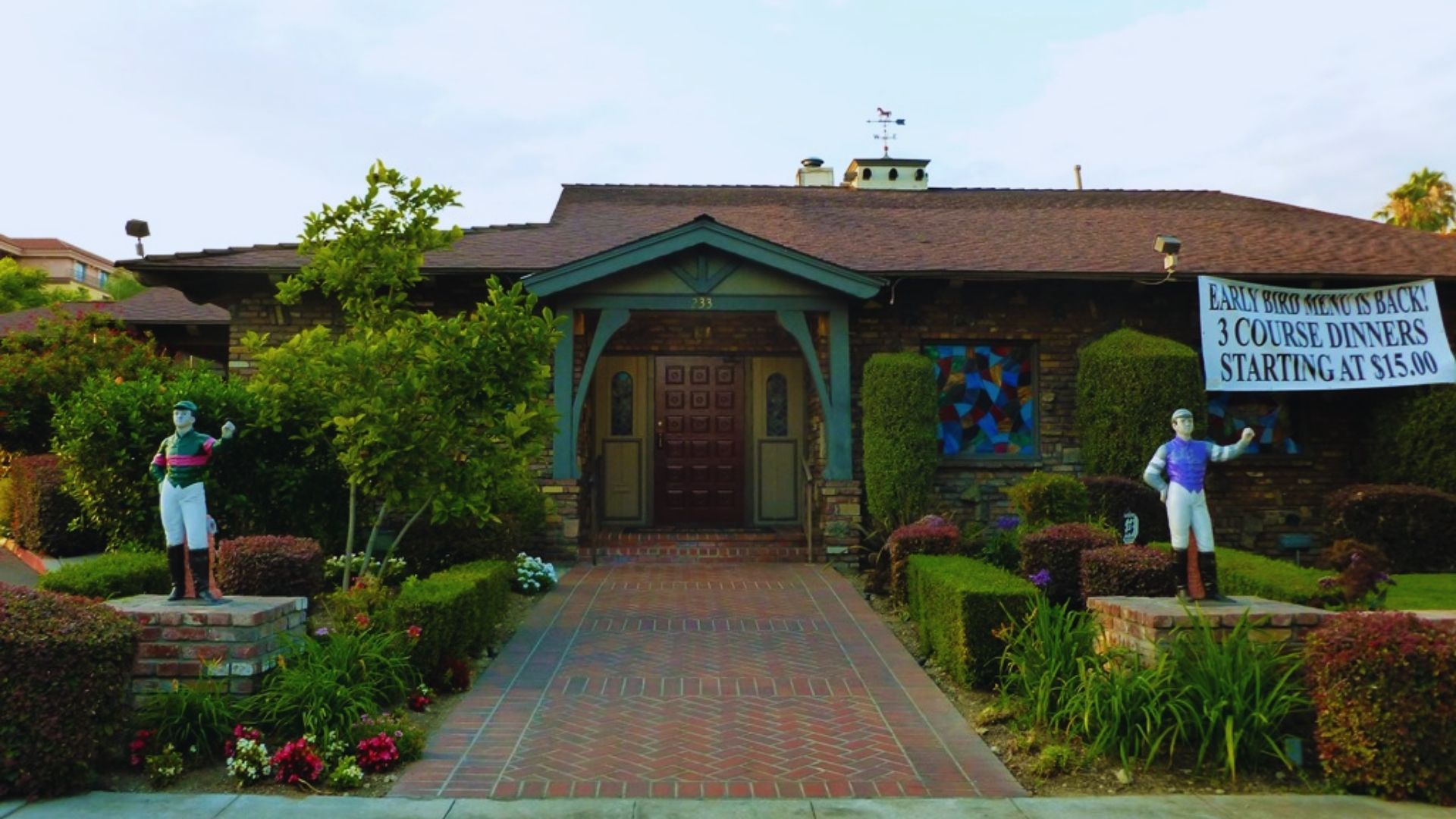  The exterior of the Jockey Club building in Los Angeles, showcasing its architectural design and surrounding landscape.