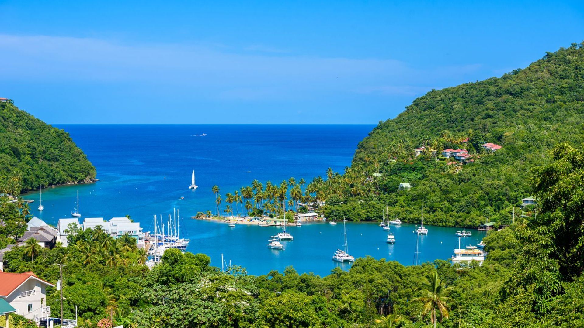 A stunning view of the bay in St. Lucia, showcasing turquoise waters and lush green hills in the Caribbean.