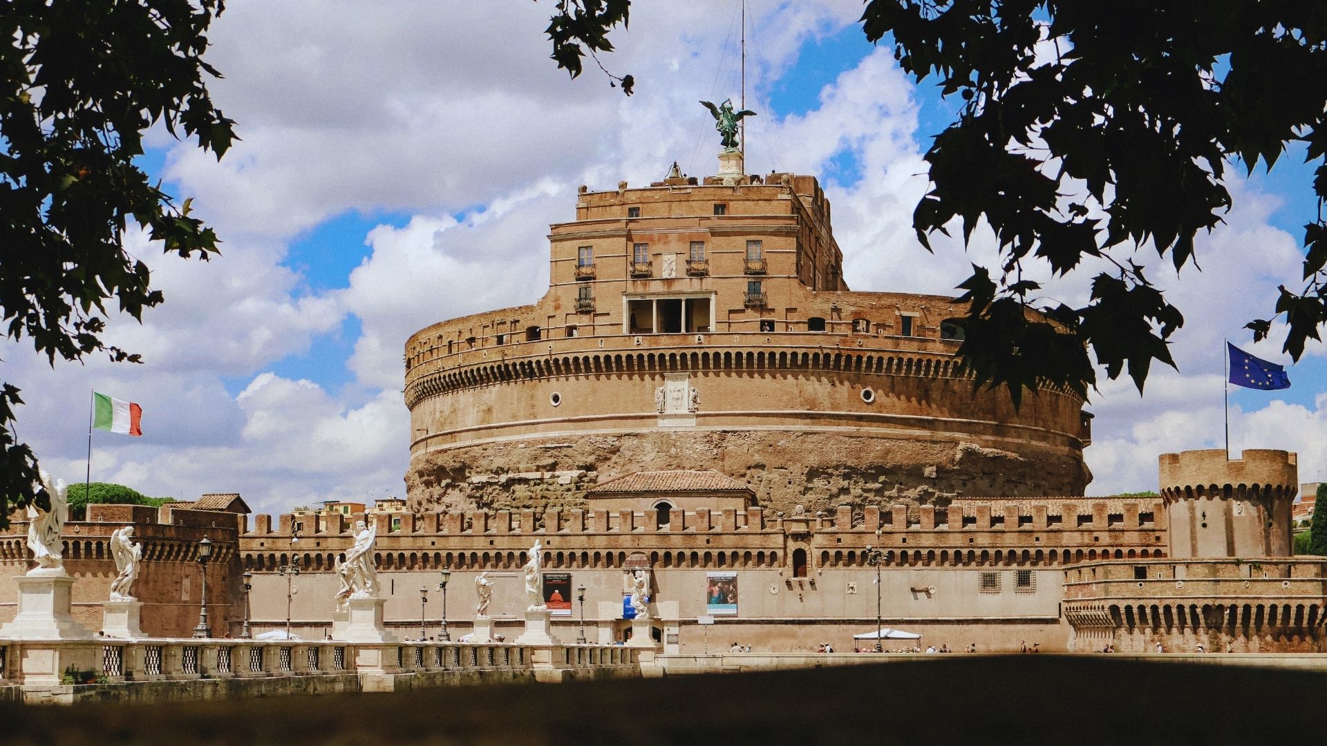 Castel Sant'Angelo in Rome, a historic fortress with a cylindrical structure and a prominent statue on top.
