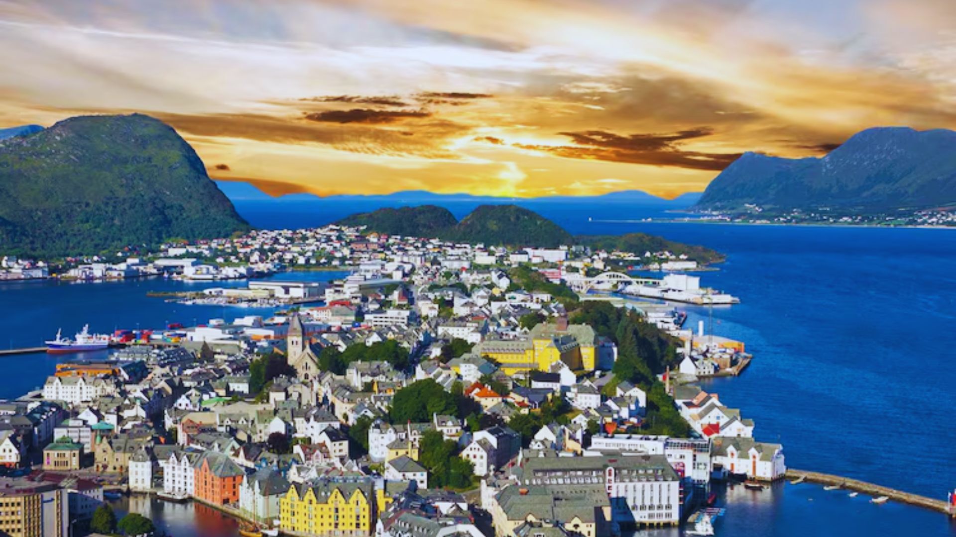 Aerial view of a coastal city at sunset, surrounded by blue waters and green mountains. Vibrant buildings and a peaceful harbor are in the foreground.