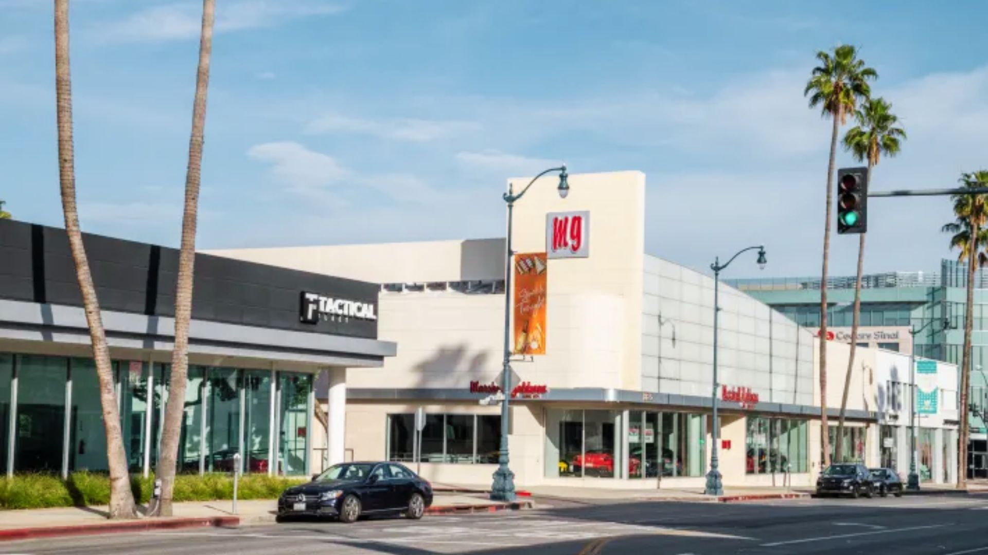 A car parked in front of a car dealership, a notable filming location from the movie Scarface in Miami, Florida
