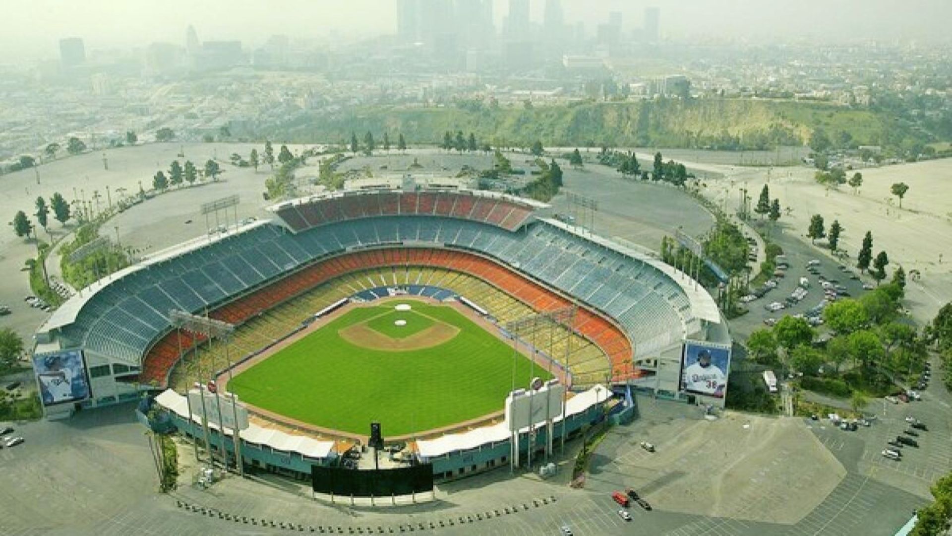 Aerial view of Dodger Stadium in California, surrounded by a city skyline in the background.
