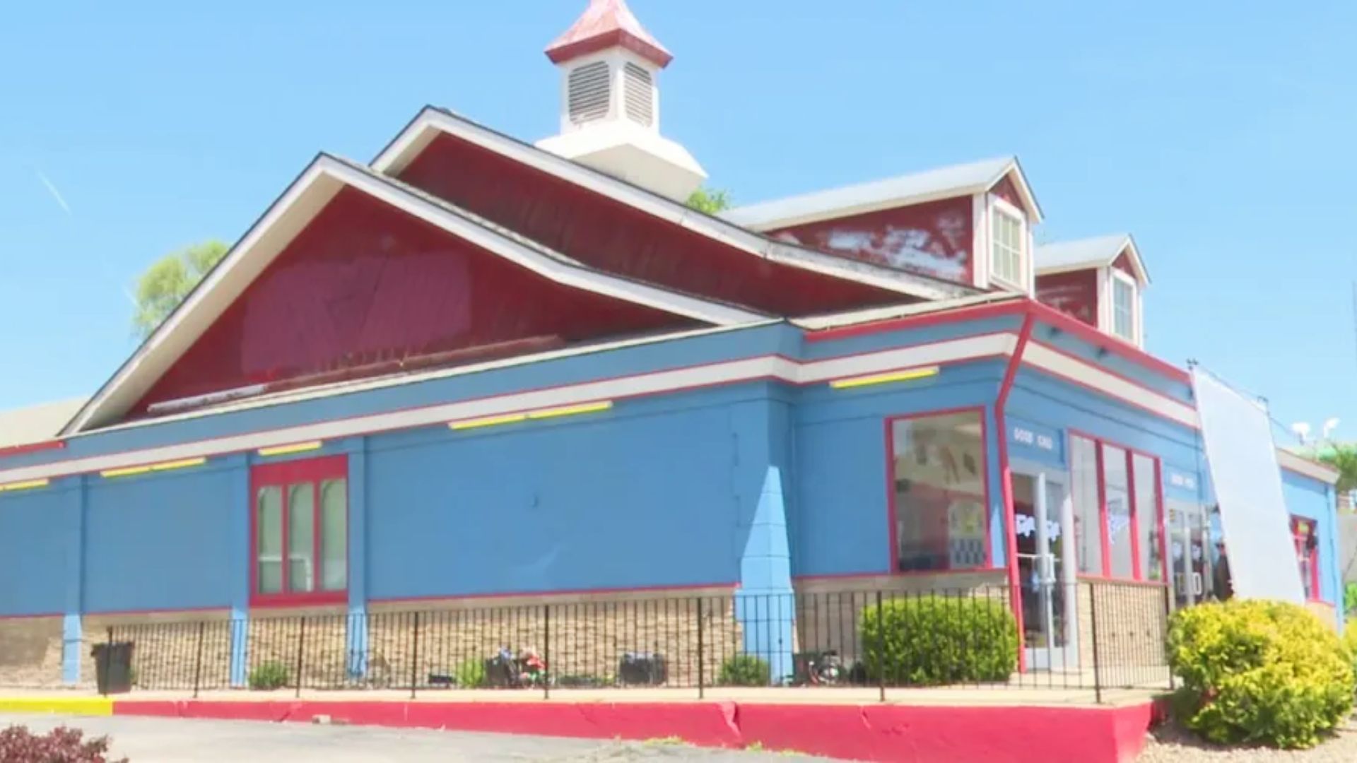 Exterior of the bright blue and red Good Burger restaurant with cupola roof, filmed for Good Burger 2.