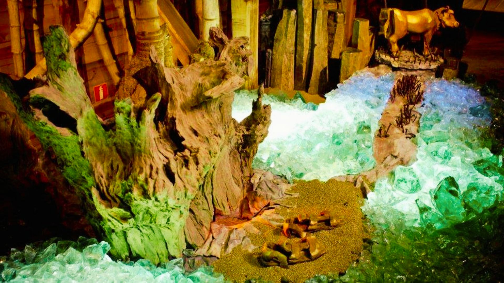 Detailed diorama of a pre-Flood world with glowing crystals, driftwood, and a golden calf idol inside the Ark Encounter.