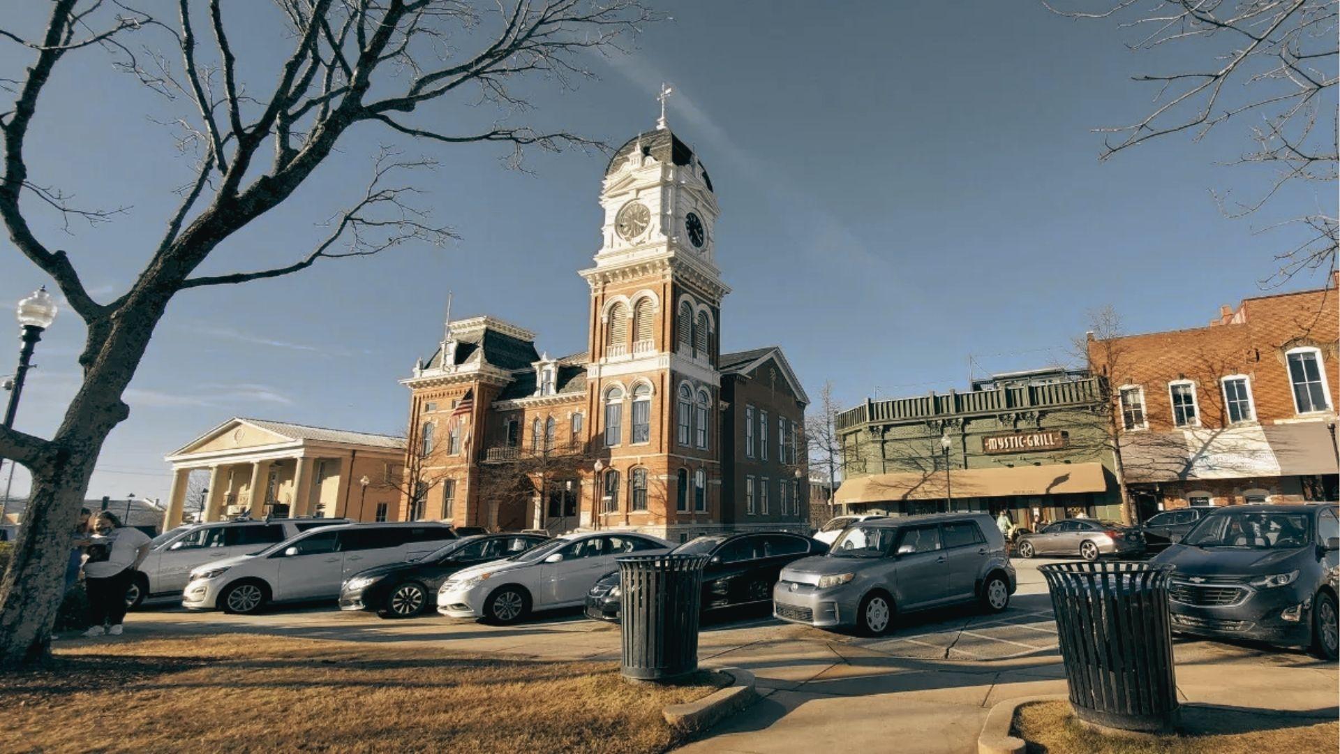 Wide view of Covington Square with the historic Newton County Courthouse clock tower and Mystic Grill.
