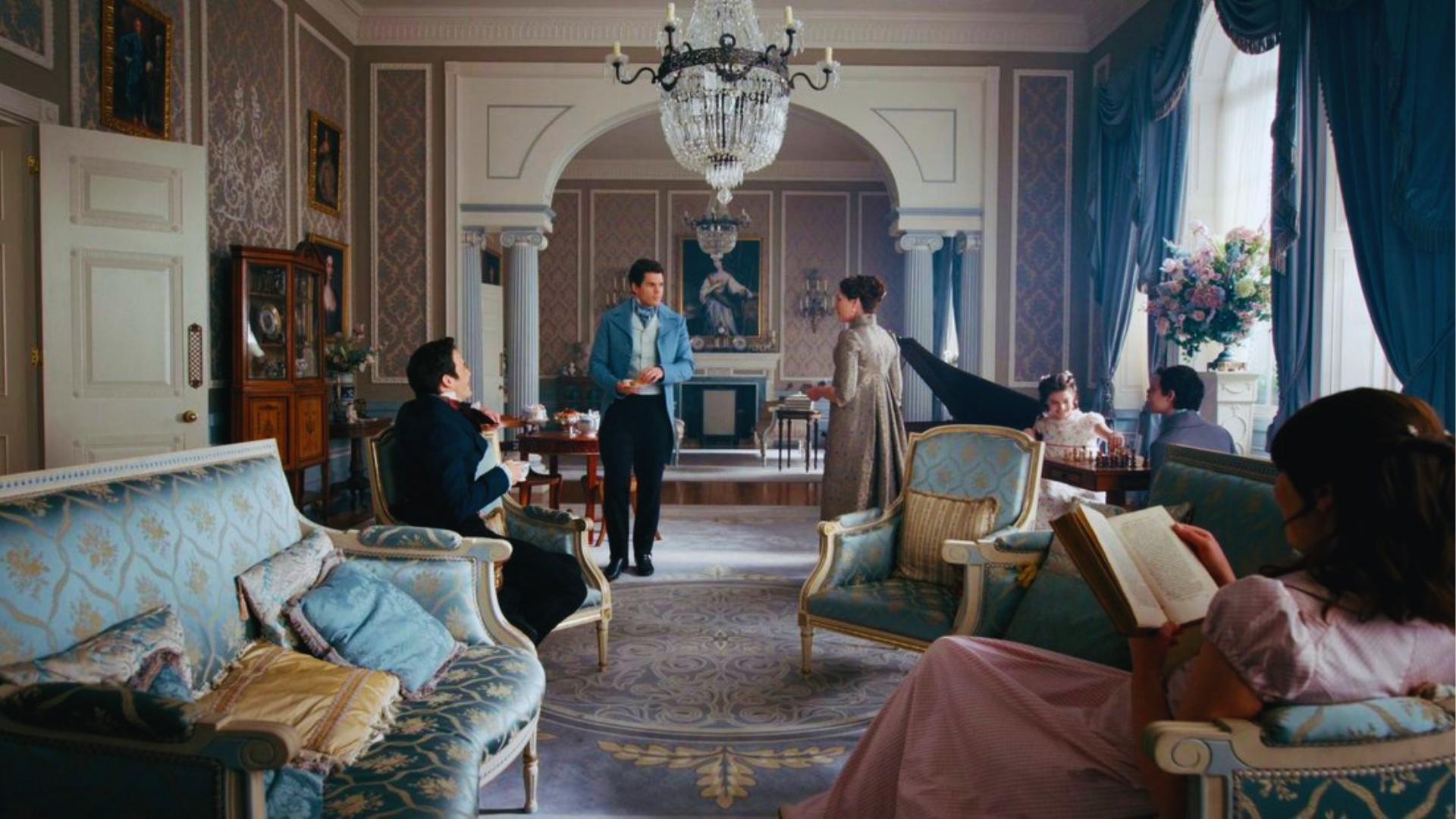 Bridgerton family drawing room with blue damask sofas, crystal chandelier, and pianoforte during afternoon tea.