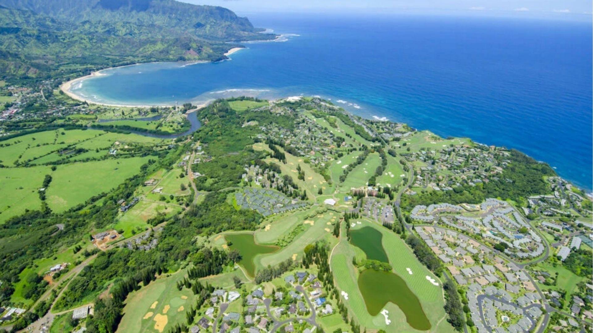 Aerial view of Hanalei Bay and Princeville, Kauai, showcasing the lush coastline used in Donovan's Reef.