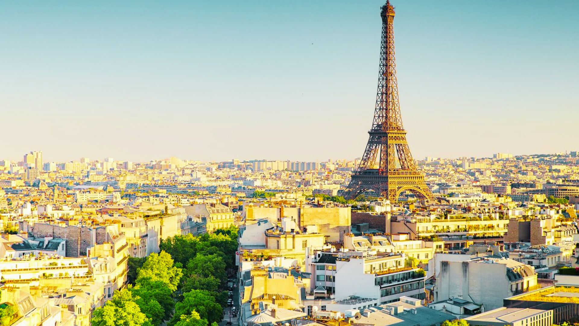 Paris skyline at sunset with Eiffel Tower view. Stay in the 16th arrondissement for upscale calm.