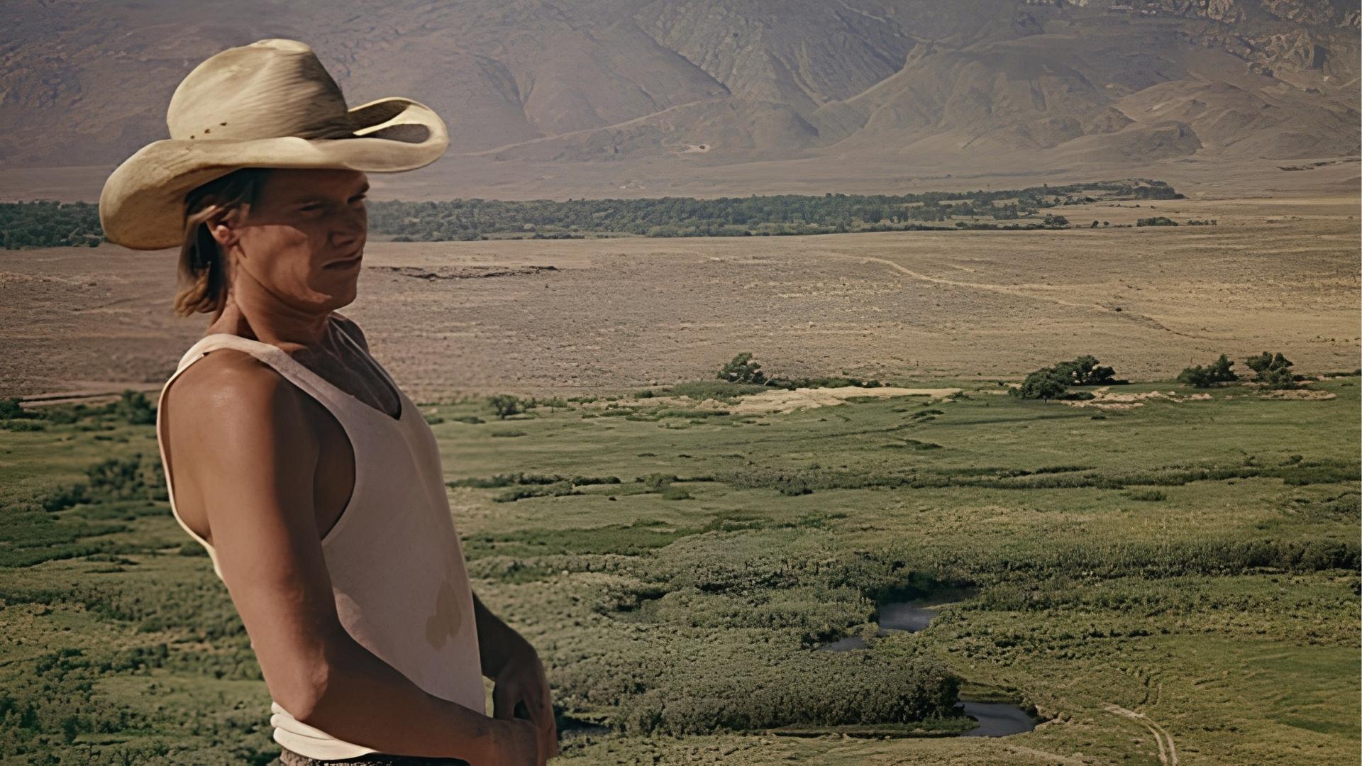 Kevin Bacon as Val in Tremors overlooks Nevada desert valley, filmed at Lone Pine standing in for Perfection.