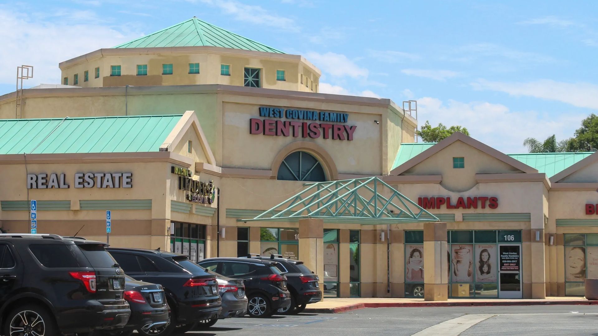 Strip mall in West Covina, California with “West Covina Family Dentistry” and “Real Estate” signs.