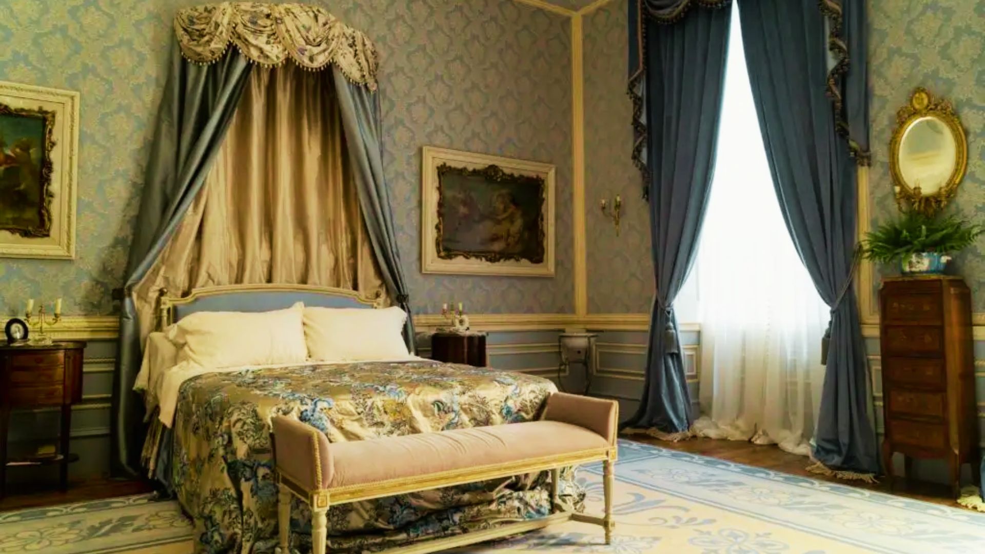 Blair Waldorf’s Parisian-influenced bedroom with blue damask wallpaper, gold silk canopy drapes, and a floral brocade bedspread.