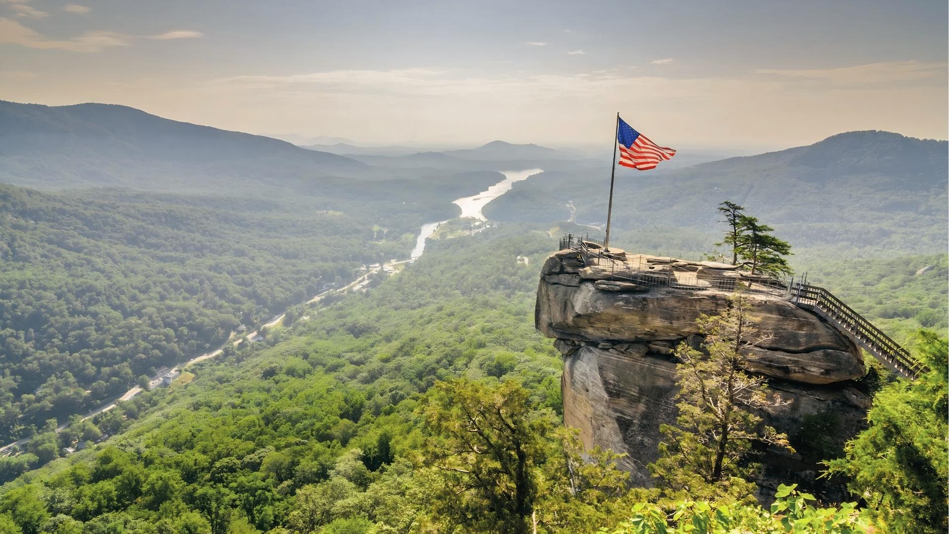 Chimney Rock overlooks with the American flag at Chimney Rock State Park, North Carolina, site of The Last of the Mohicans final scene.