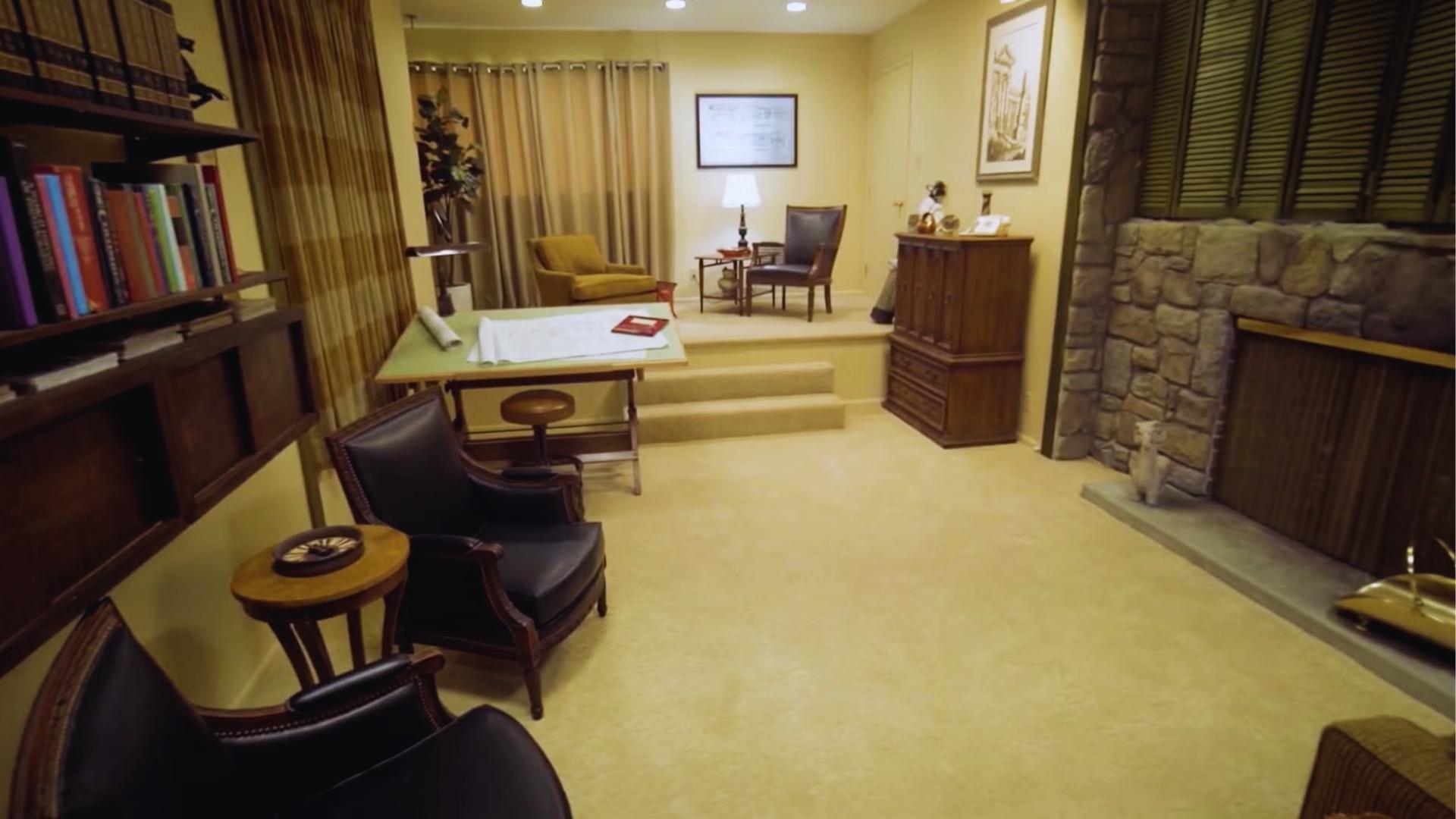 Mike Brady’s home office in The Brady Bunch with drafting table, stone fireplace, and black leather chairs.