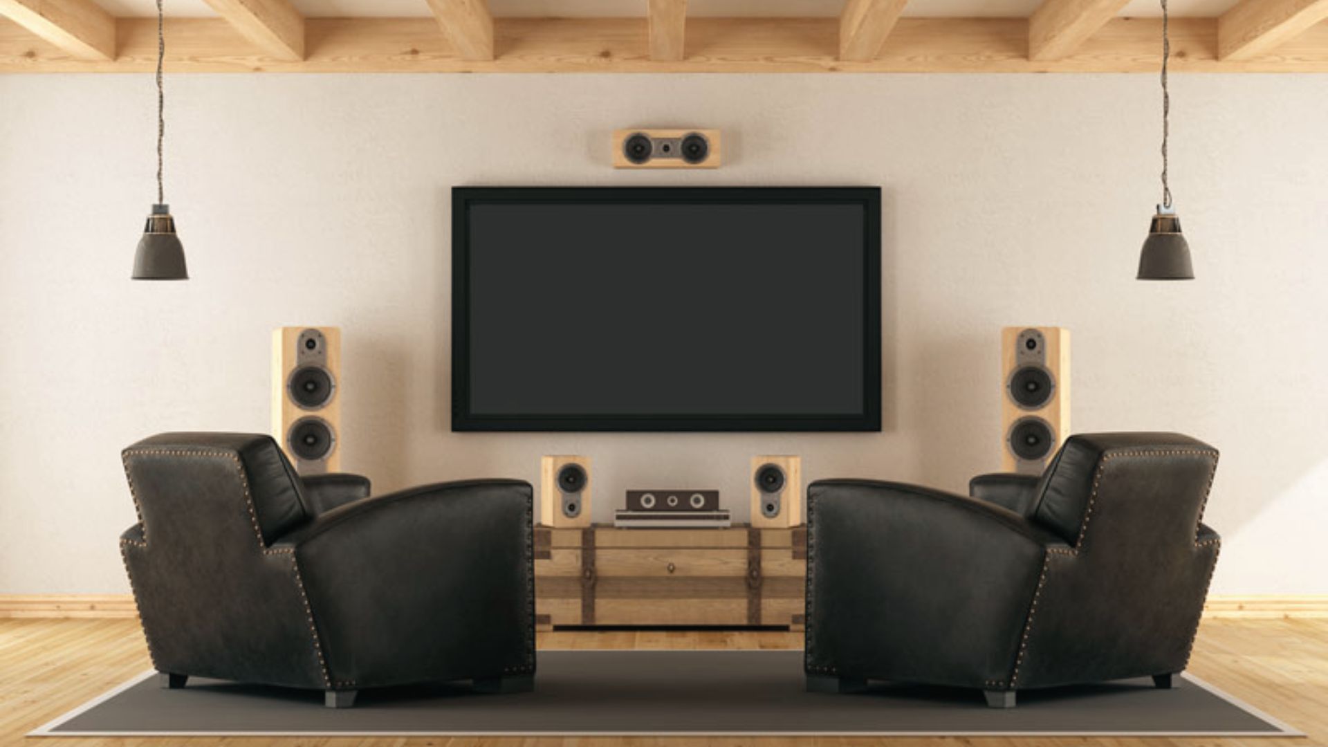 Minimalist rustic movie room with two black leather chairs facing a wall-mounted TV.