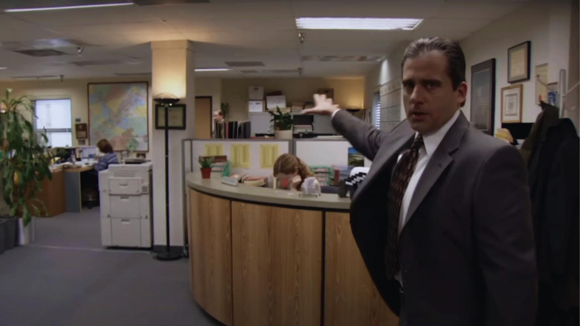 Michael Scott gestures at Dunder Mifflin reception on The Office set, built inside Chandler Valley Center Studios in California.