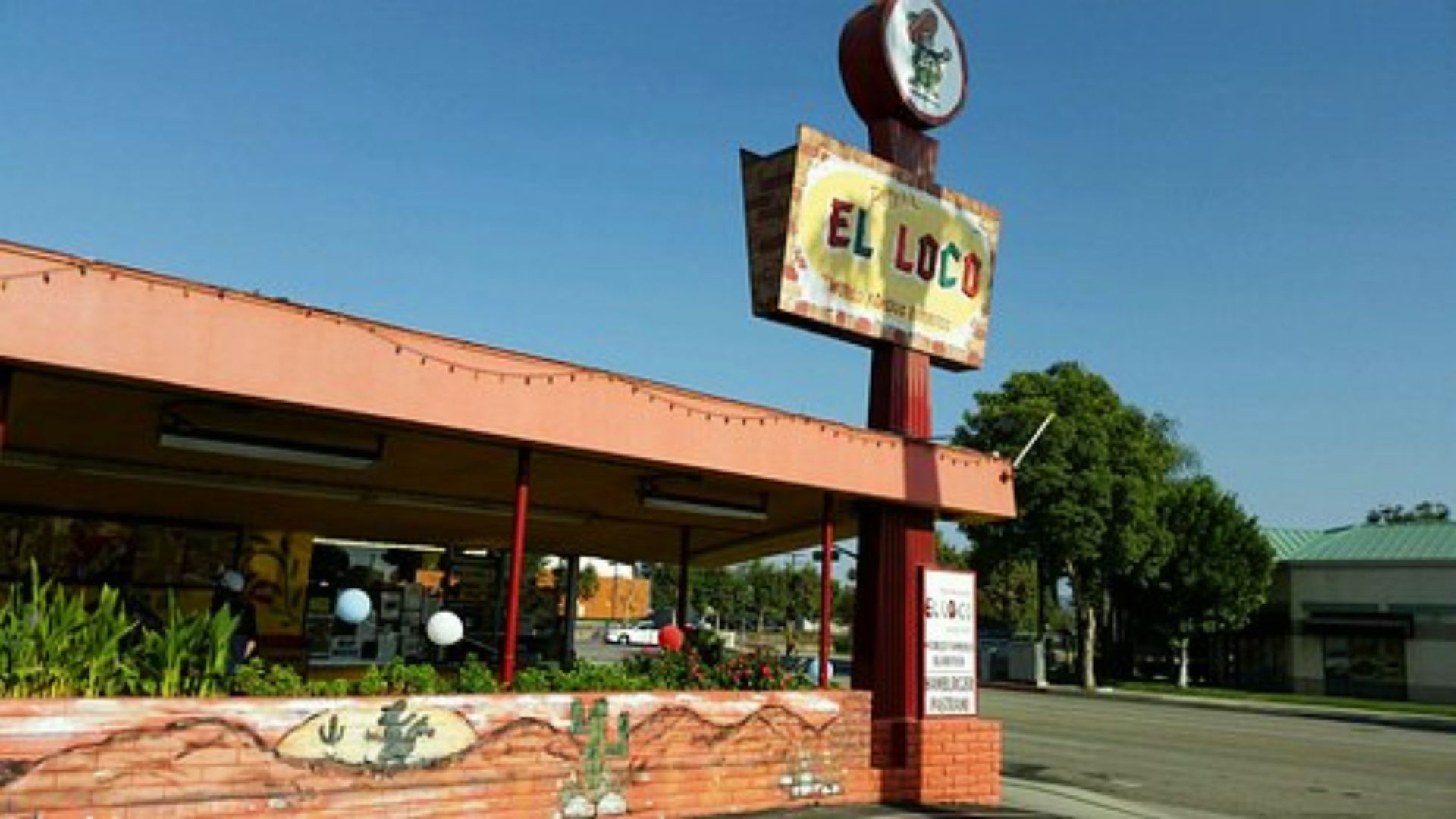 El Loco drive-in with vintage “El Loco” sign and red roof, transformed into Mondo Burger.