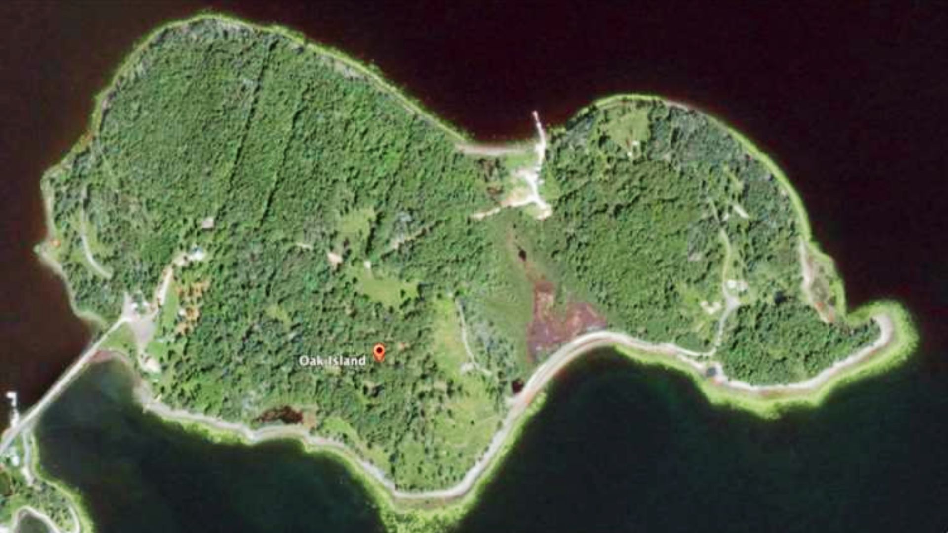 Satellite map view of Oak Island, Nova Scotia with dense forest and marked location pin.