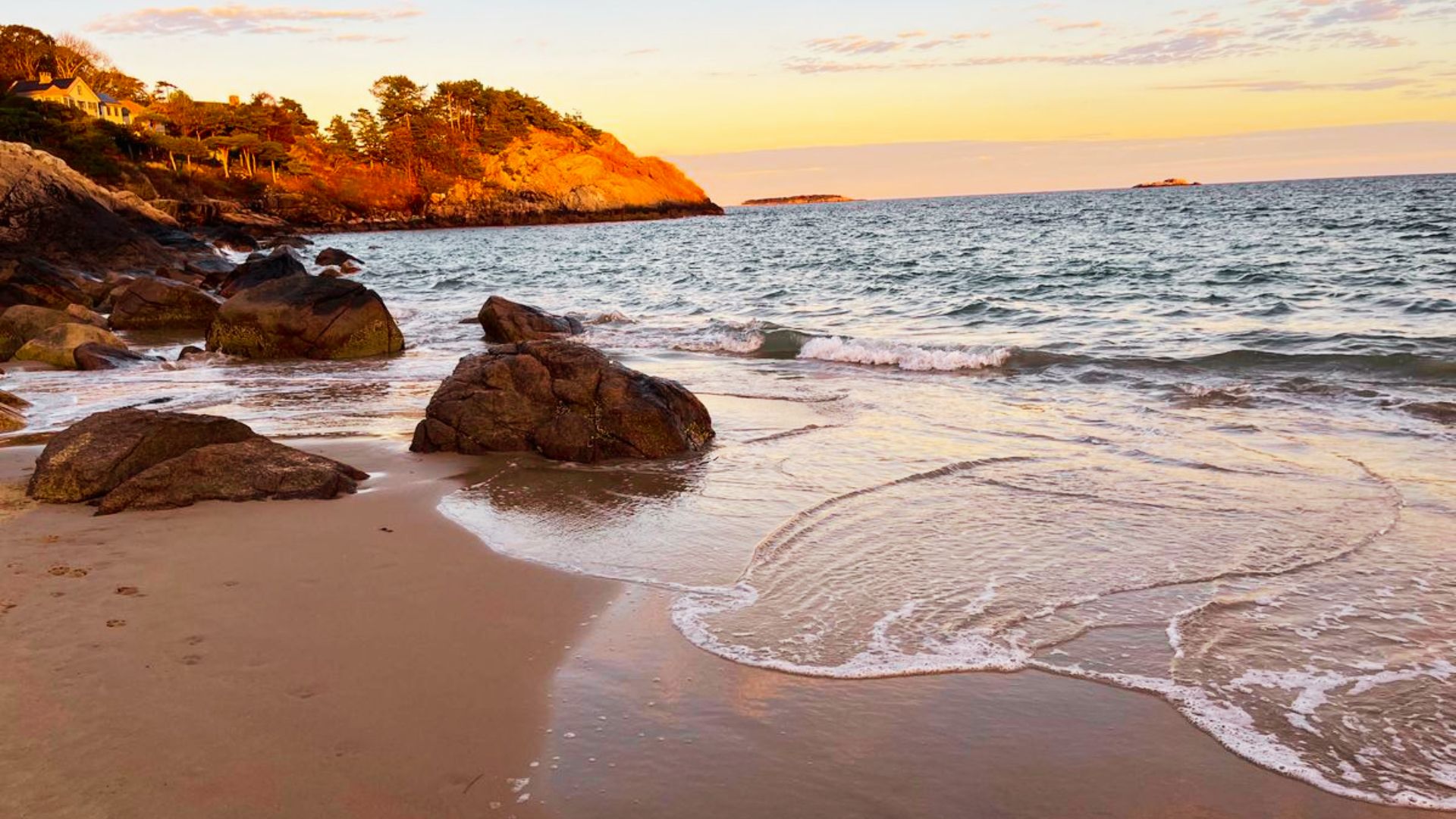 Singing Beach a Golden sunset light warms a rocky coastline in Manchester-by-the-Sea