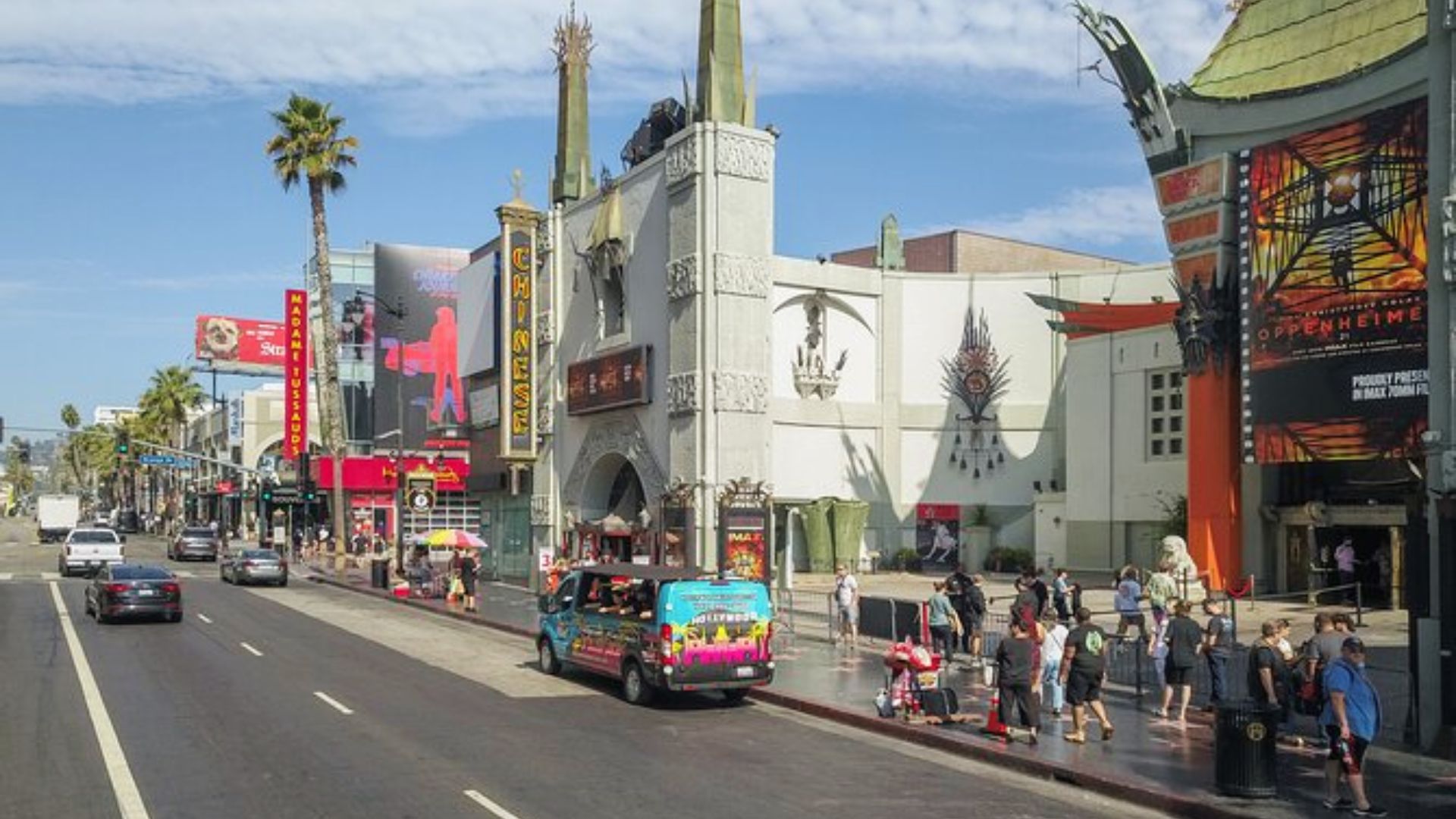 A busy street view of Hollywood with the TCL Chinese Theatre, palm trees, and tourists.