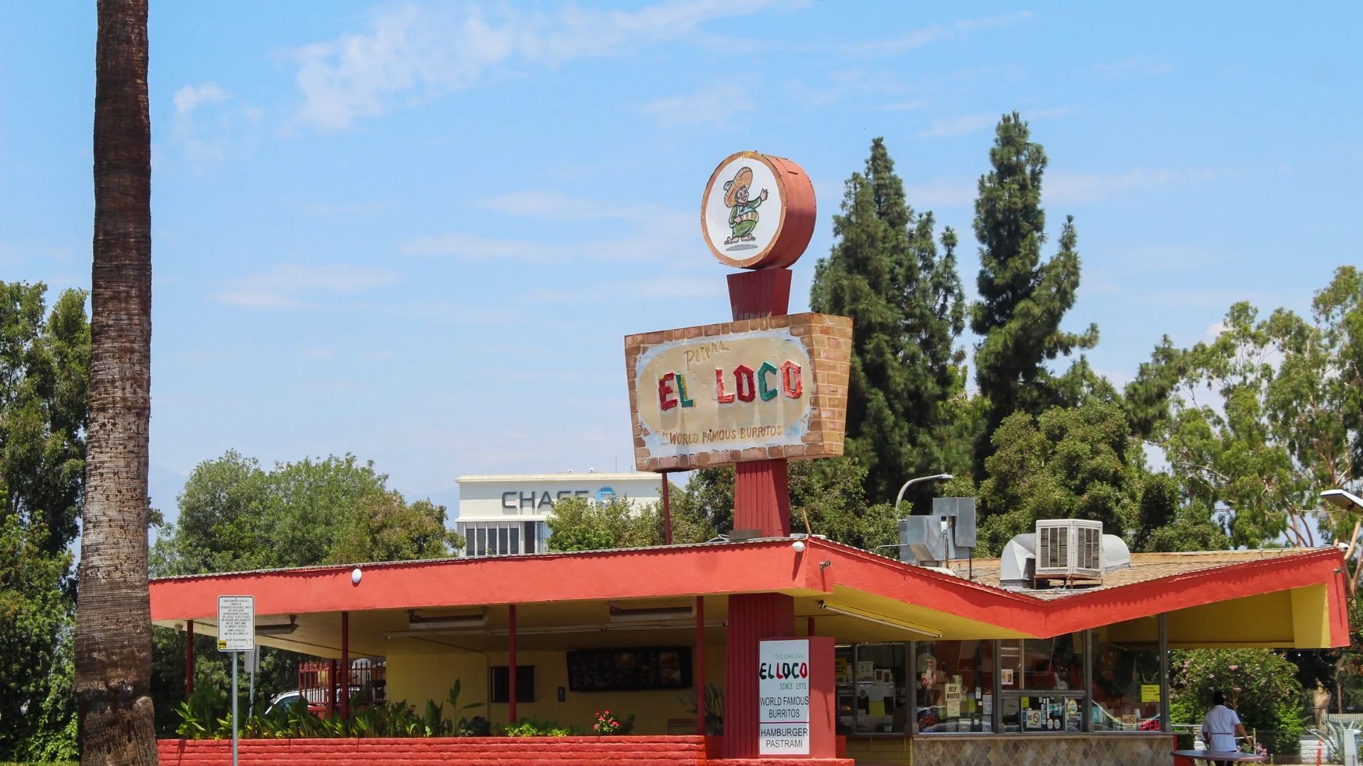 Daytime view of Peter’s El Loco restaurant with brick planters and Chase bank in the background.