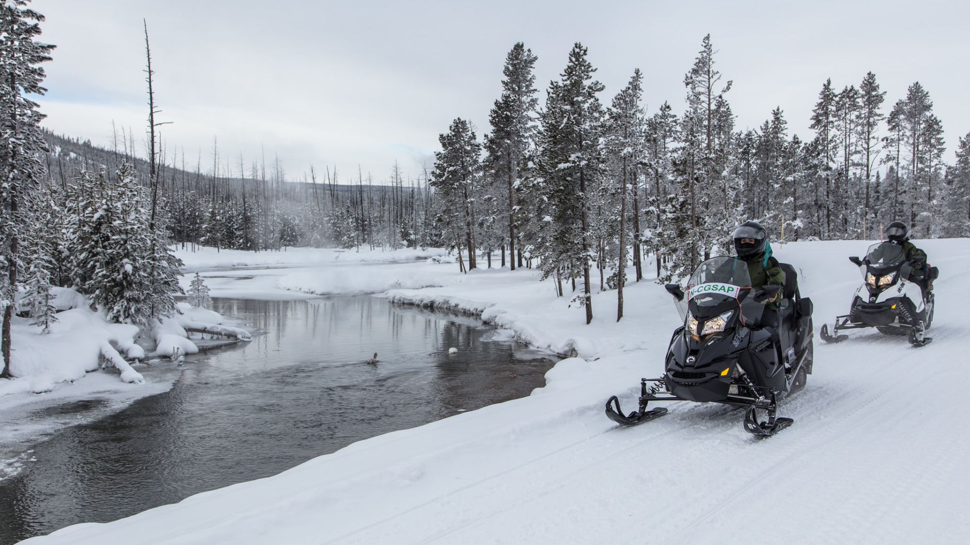 TWO MEN SNOWMOBILING
