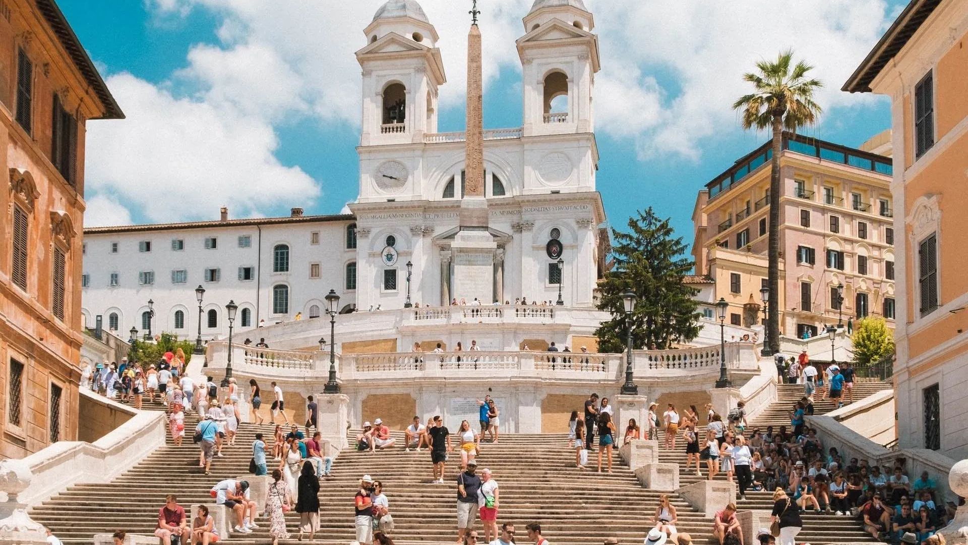A PHOTO OF SPANISH STEPS WITH PEOPLE SITTING ON IT
