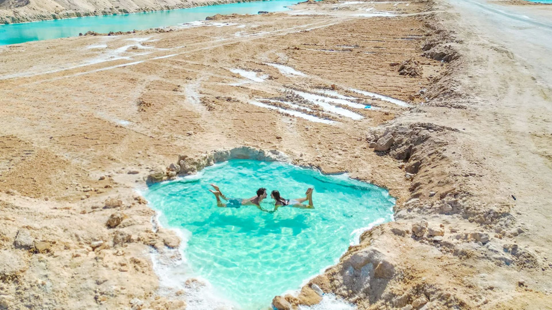 IMAGE OF TWO PEOPLE SWIMMING IN SIWA OASIS
