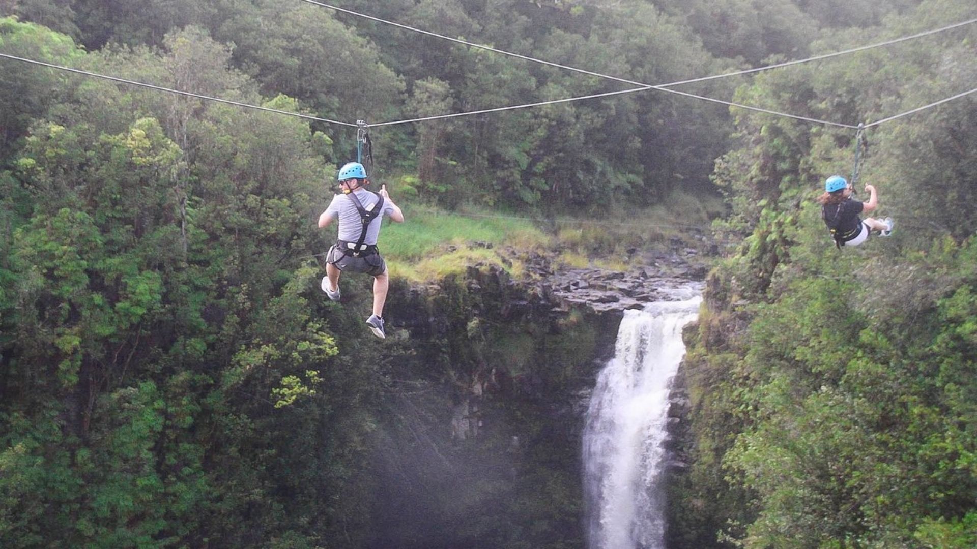 A MAN GOING THROUGH ZIPLINING
