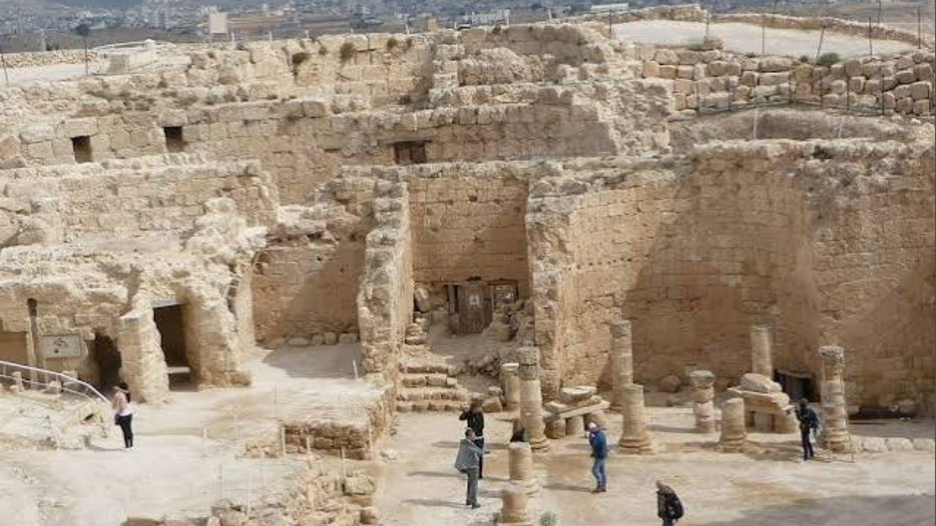 Tourists explore stone ruins and columns at Herodium, Israel, a Jesus Christ Superstar filming location.
