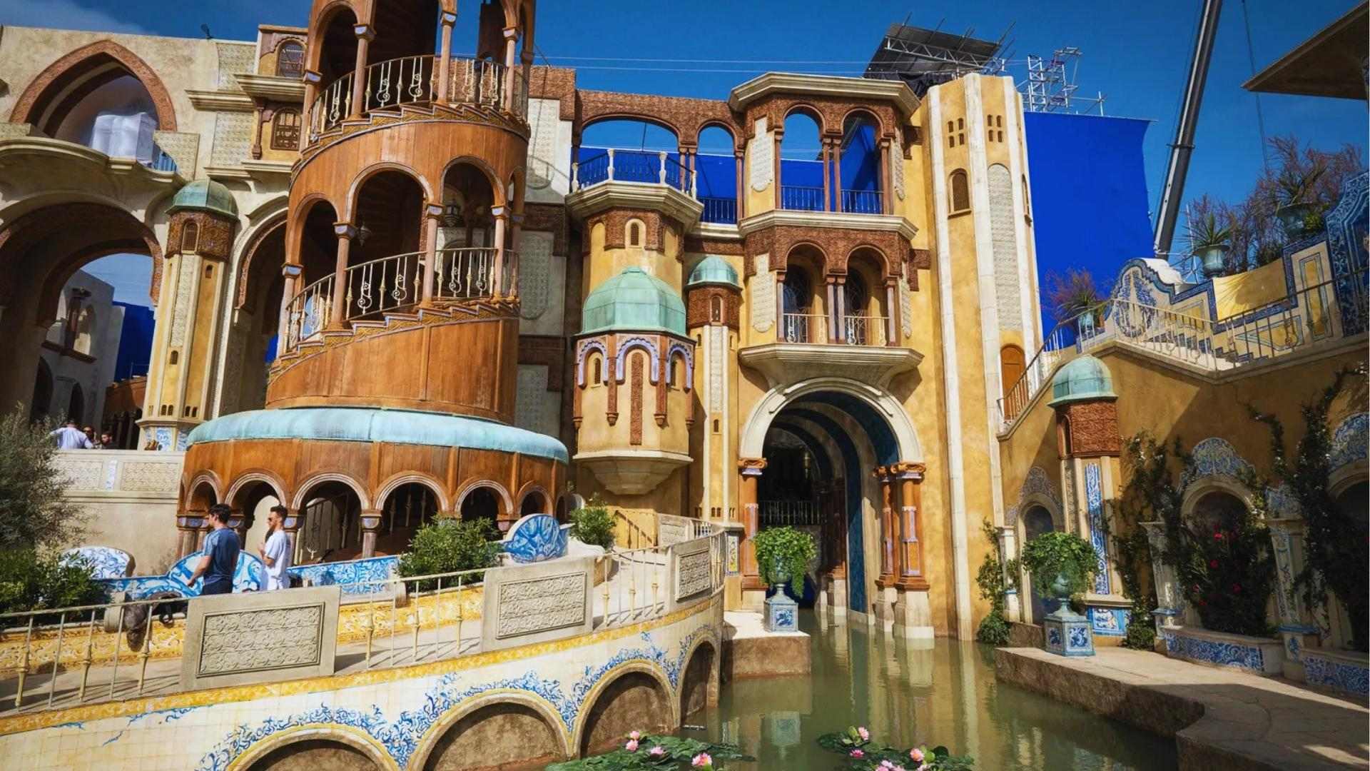 Munchkinland set with blue domes and waterway built at Sky Studios Elstree for Wicked movie.