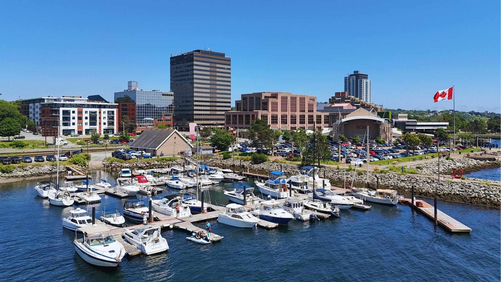 Dartmouth marina with boats and Canadian flag in Nova Scotia, town location used in We Were Liars series.