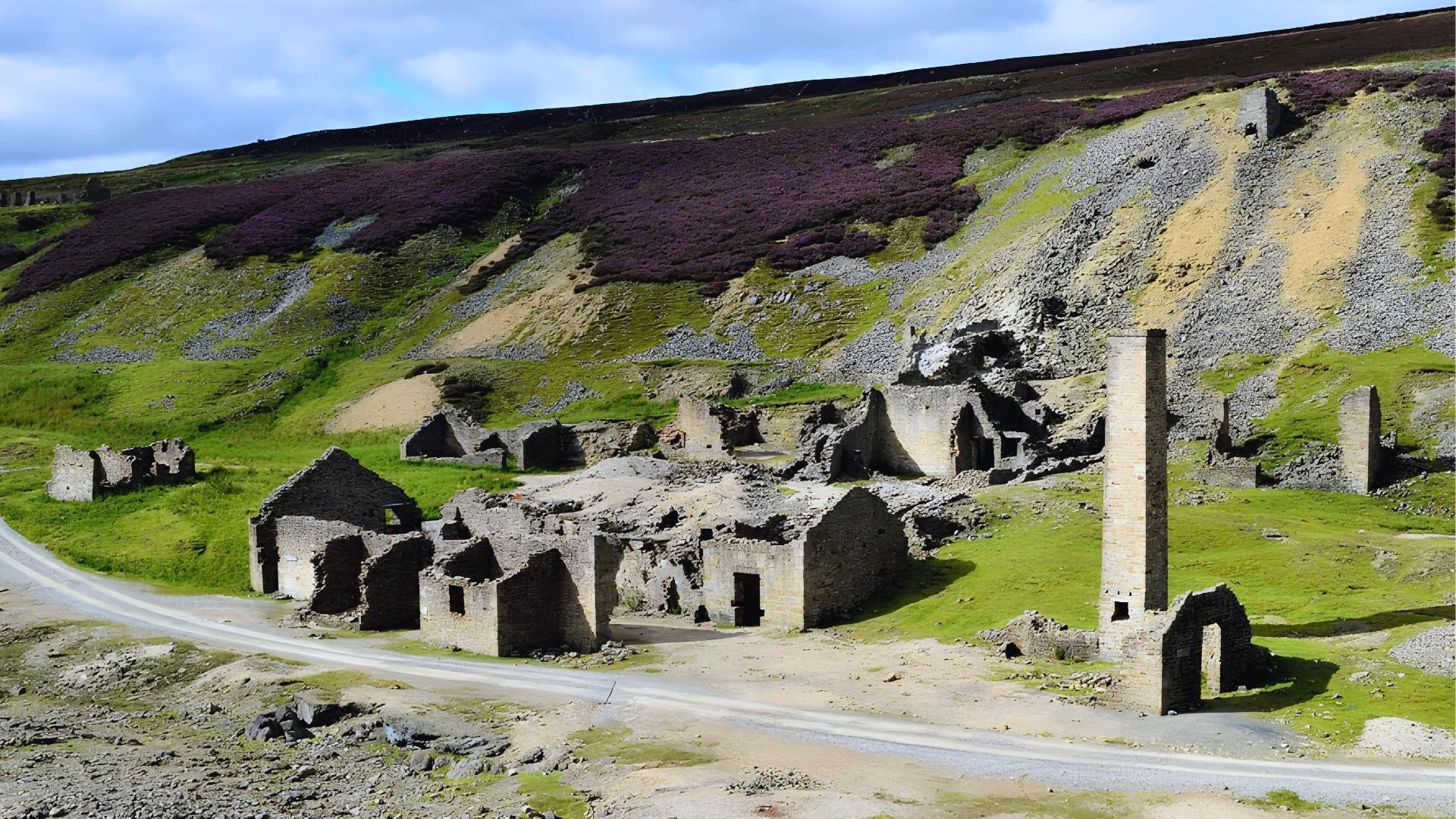 Ruins of Old Gang Smelt Mill in Yorkshire Dales with heather hills, moody Wuthering Heights filming backdrop.