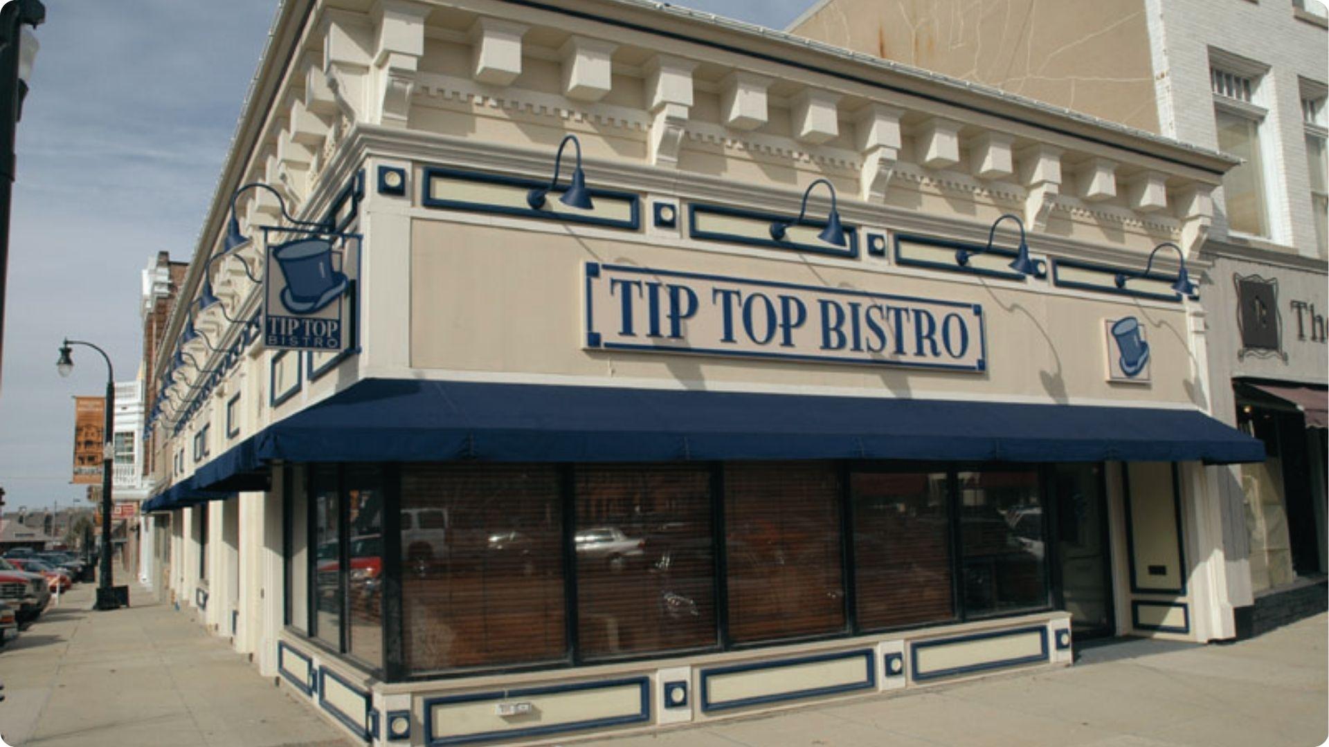 Tip Top Bistro corner building with blue awnings. Renamed Tip Top Cafe for Groundhog Day shoot.