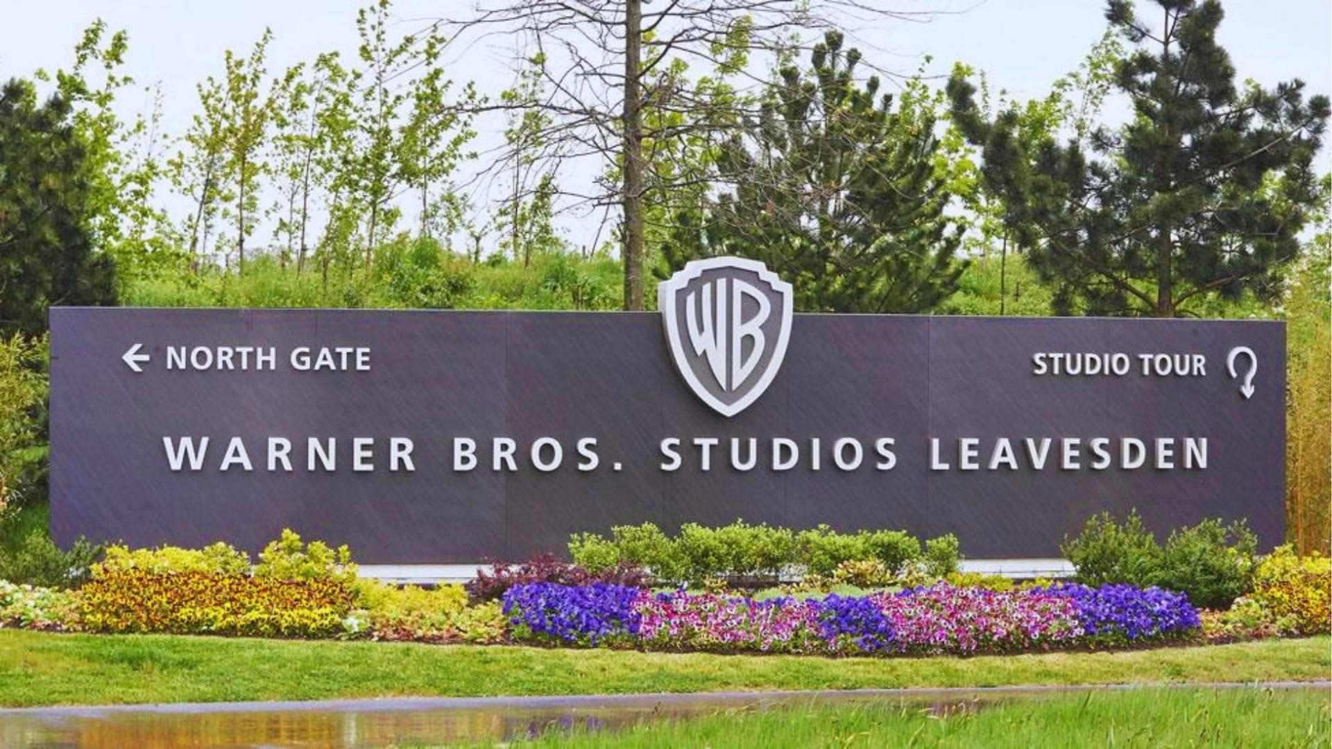 Warner Bros. Studios Leavesden entrance sign with WB logo, production hub for Wicked movie in England.