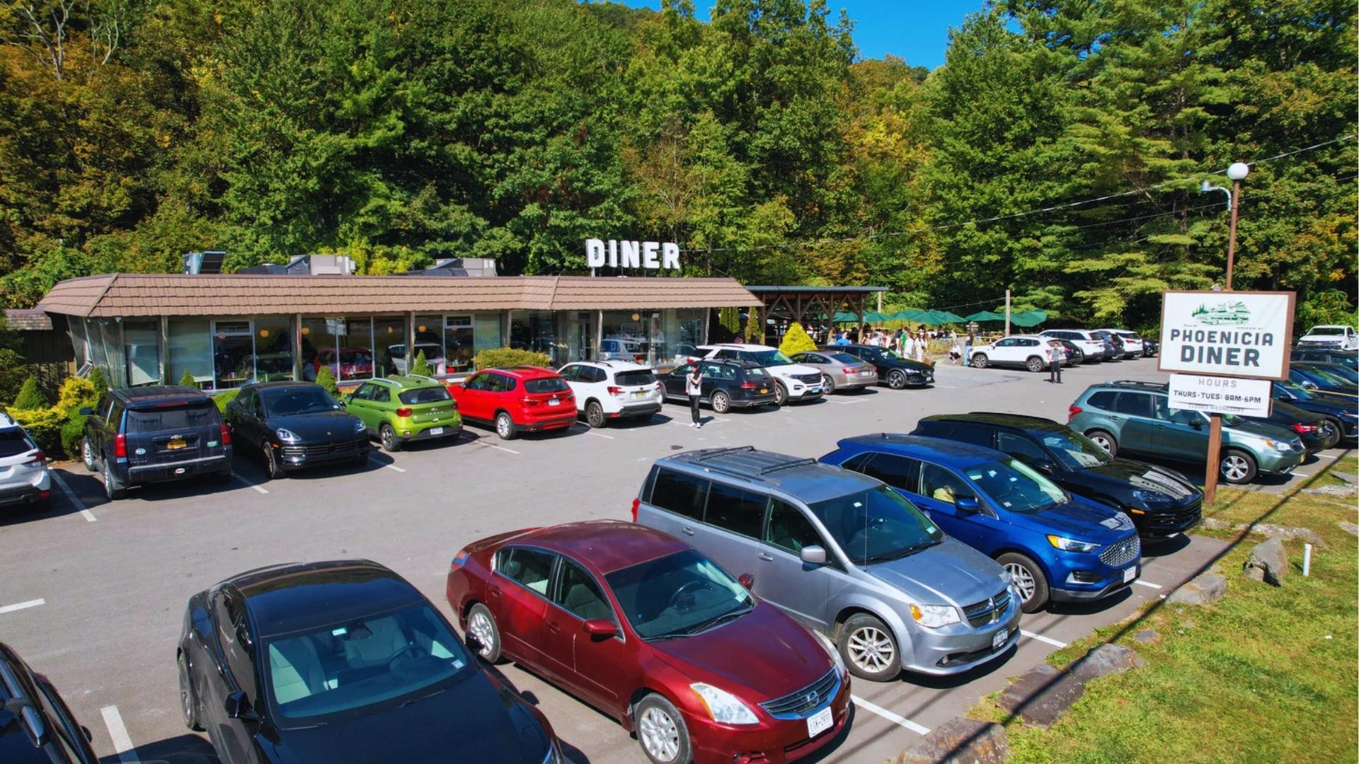 Phoenicia Diner with full parking lot and forest backdrop in New York’s Catskills, featured as “Pip’s Bar & Grille” in Severance.