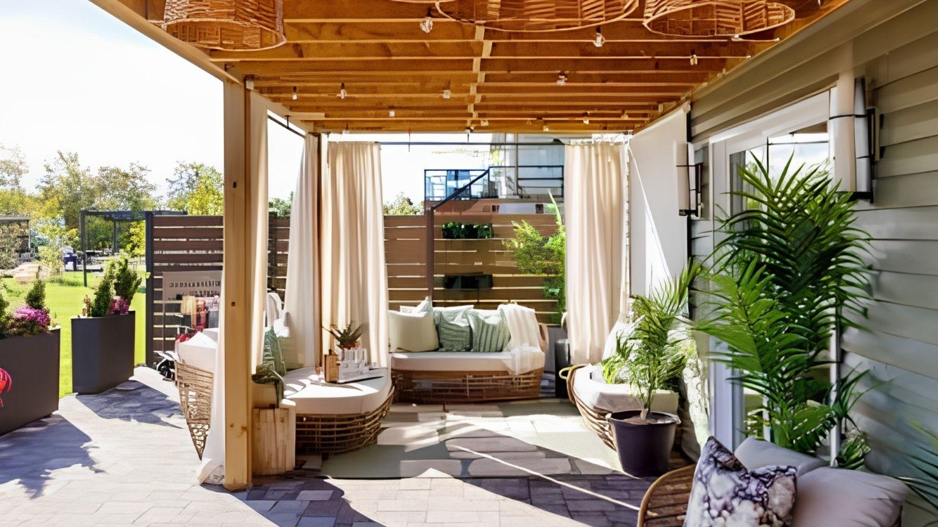 Renovation Resort Showdown. Cozy pergola patio with cream curtains, wicker daybeds.