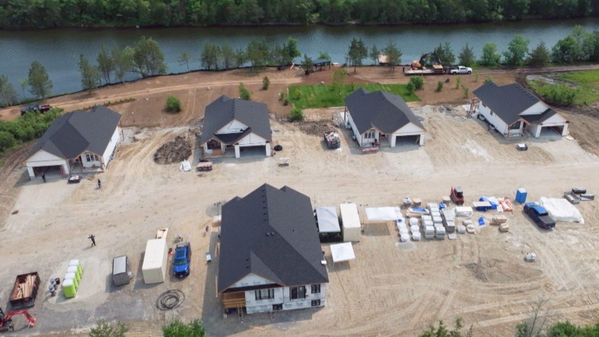 Renovation Resort Showdown. Aerial of multiple white-roofed homes under construction.