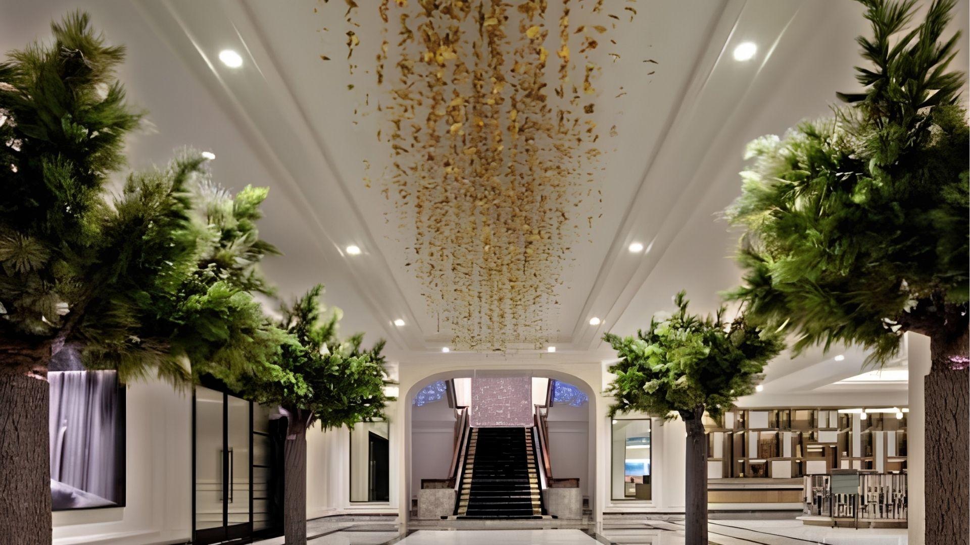 Luxury hotel lobby with indoor trees and staircase from The Fugitive