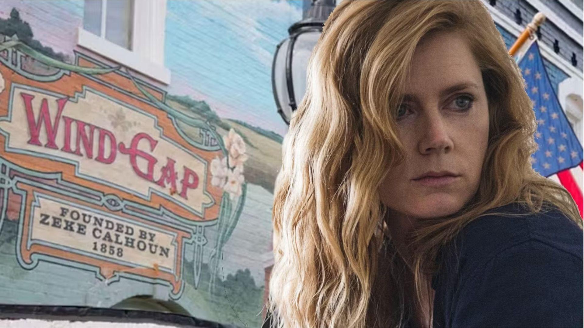 Amy Adamsas Camille Preaker by Wind Gap town mural in Sharp Objects