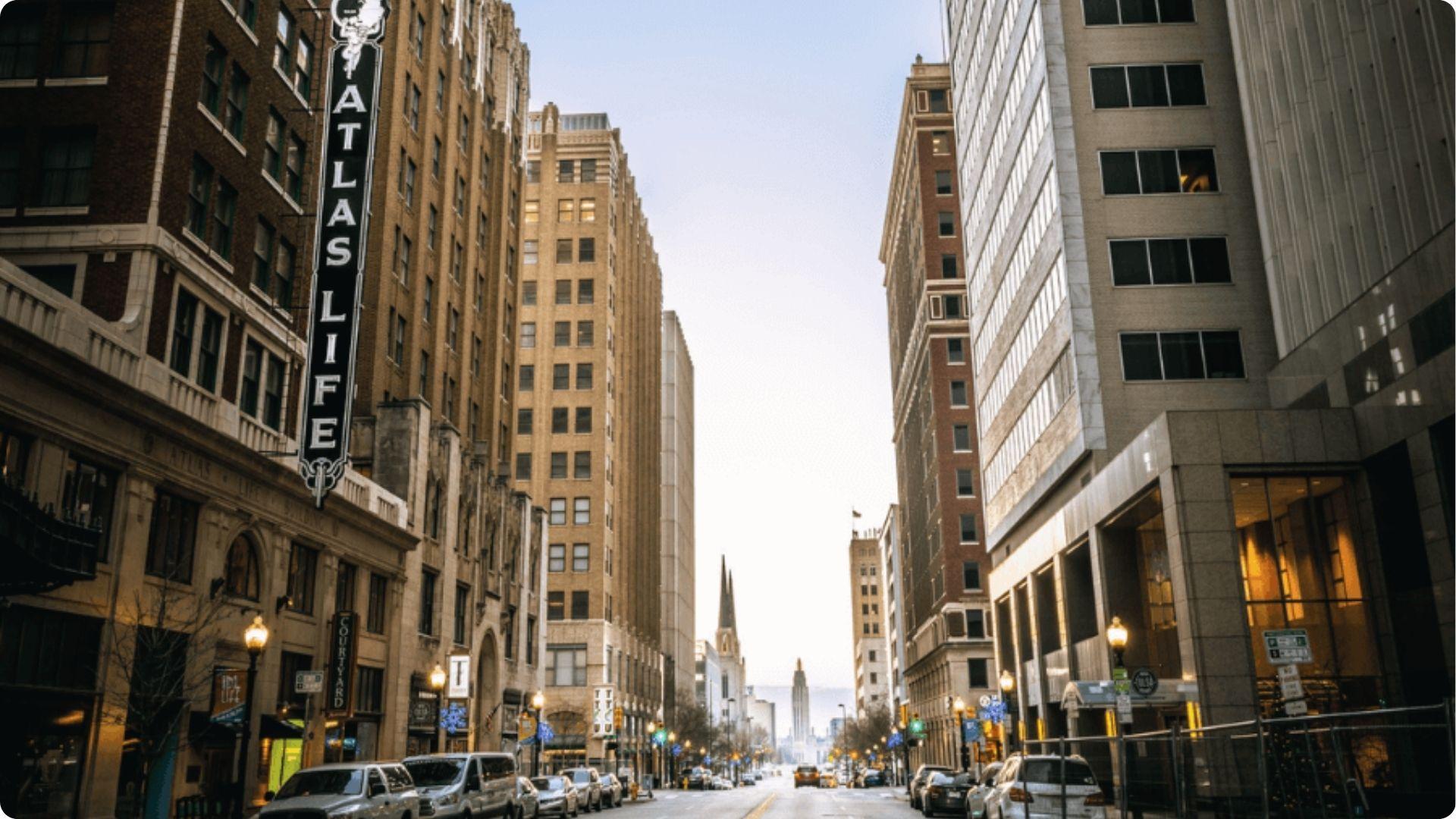 Downtown Tulsa street view showing the Atlas Life building sign and Boston Avenue at dusk, a key backdrop for Tulsa King scenes.