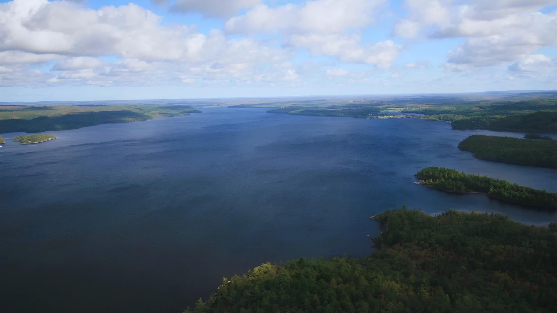 Aerial of Lake with forested islands in Nova Scotia, filming location for Beechwood Island in We Were Liars.