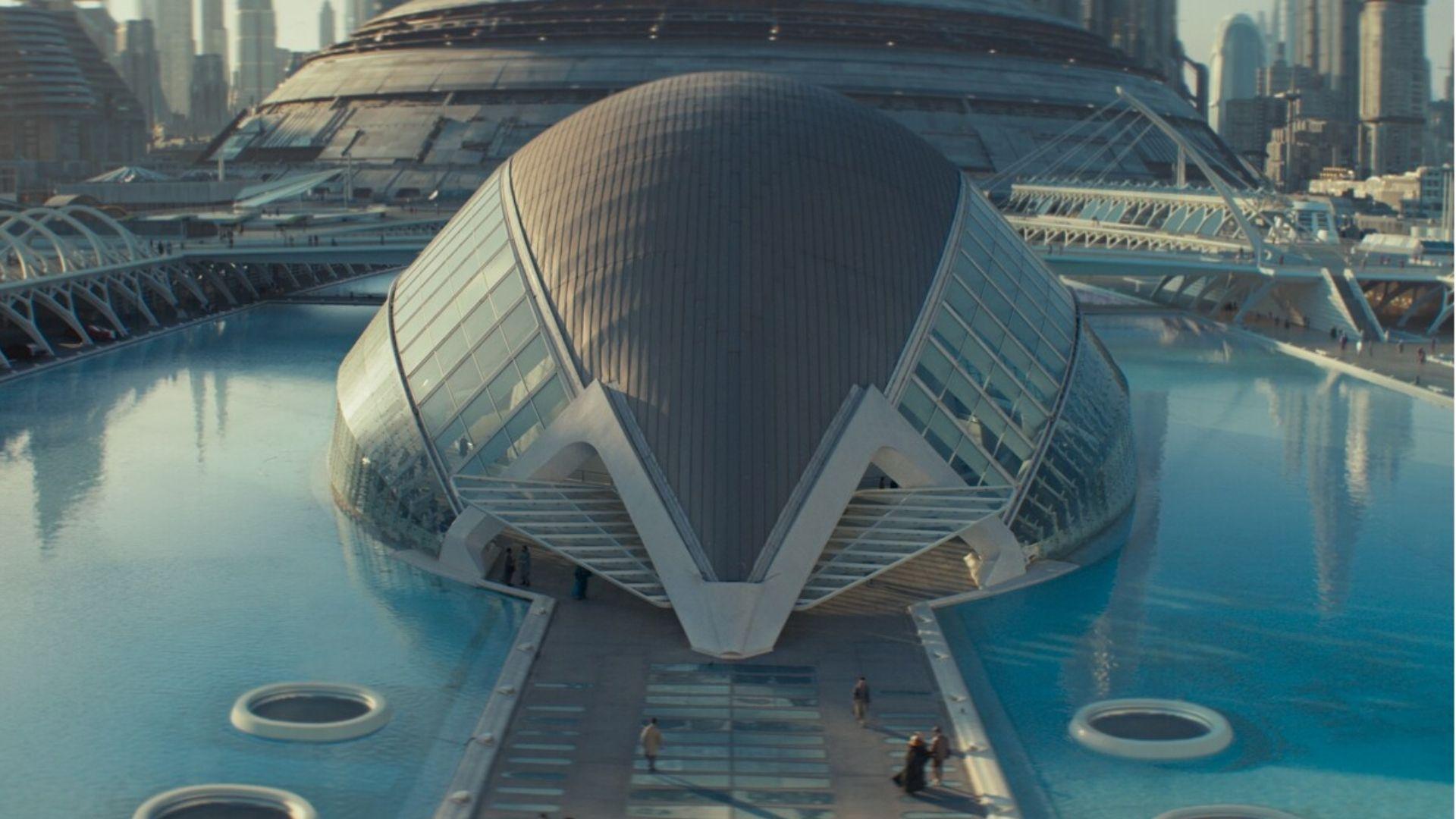 L'Hemisfèric in Valencia reflected in water, digitally enhanced with a futuristic cityscape.