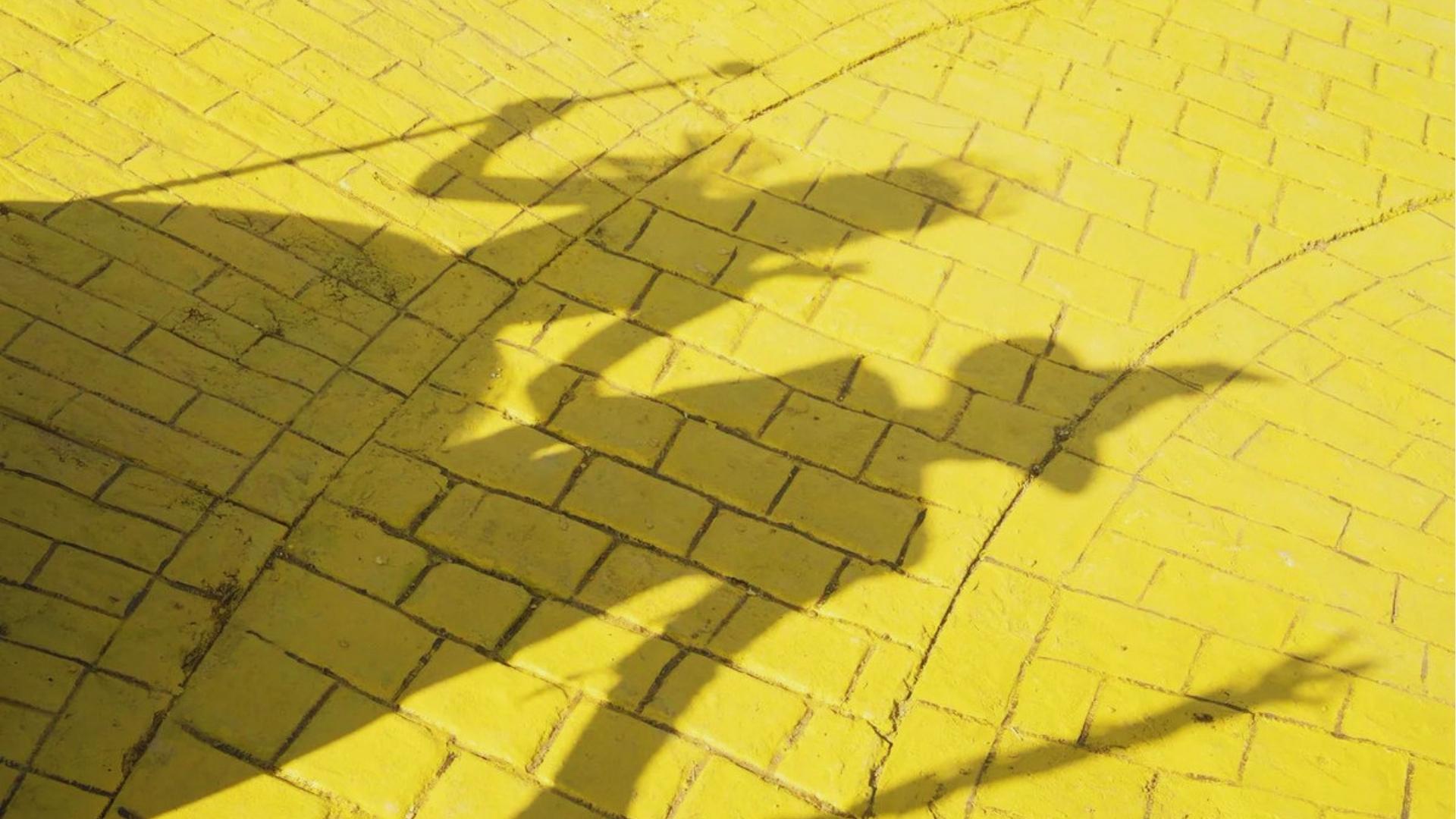 Shadows of Elphaba and Glinda on Yellow Brick Road, practical set built for Wicked at Sky Studios Elstree.