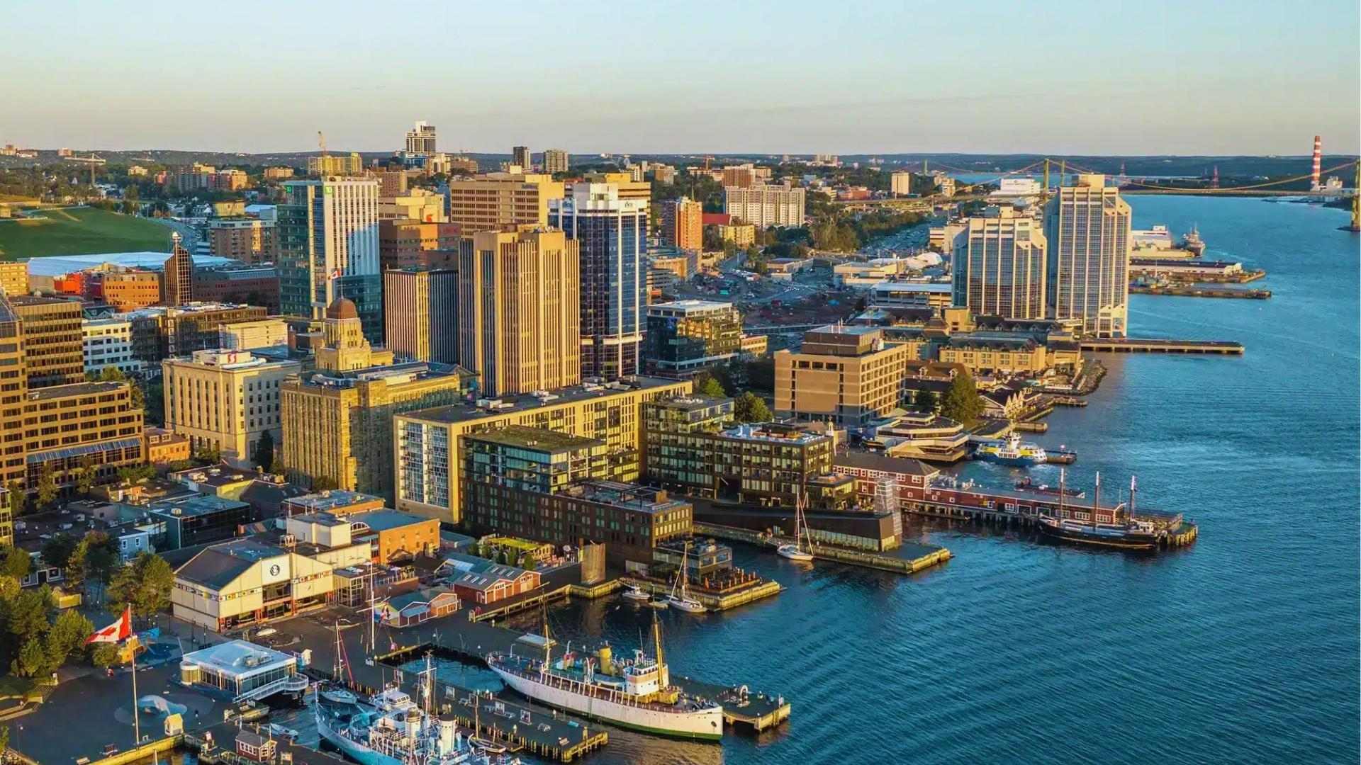 Halifax waterfront skyline at golden hour in Nova Scotia, featured in We Were Liars establishing shots.