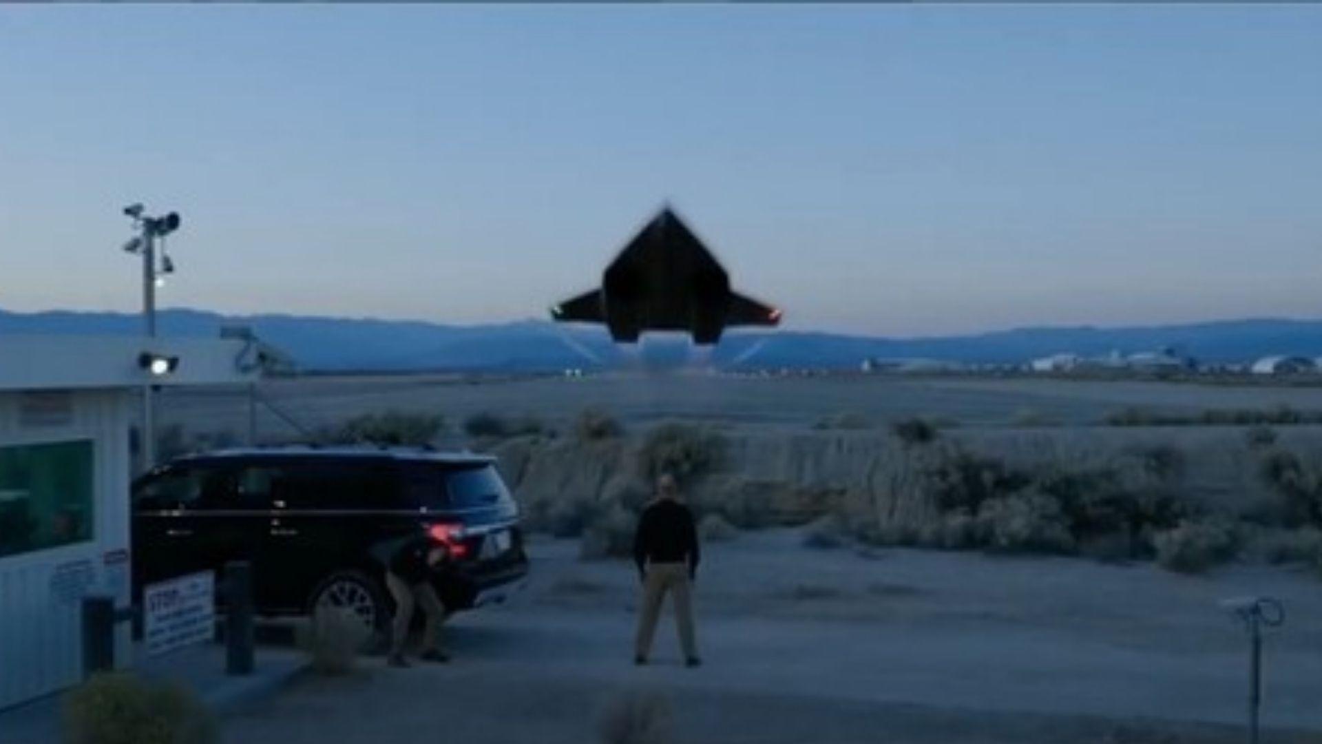 Dark experimental aircraft lifting off above a desert runway in a memorable opening scene from Top Gun: Maverick.