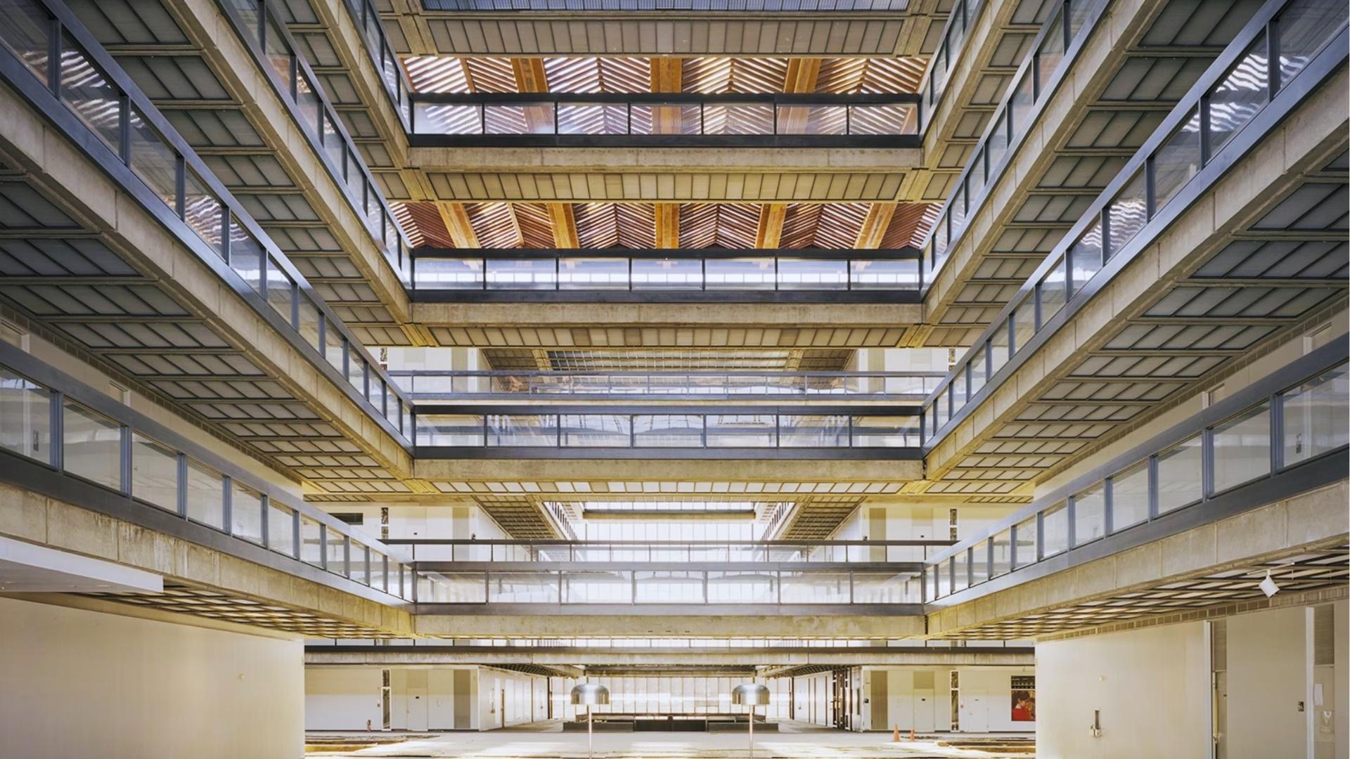 Bell Labs empty atrium with symmetrical balconies, iconic Brutalist Severance location doubling as Lumon’s halls.