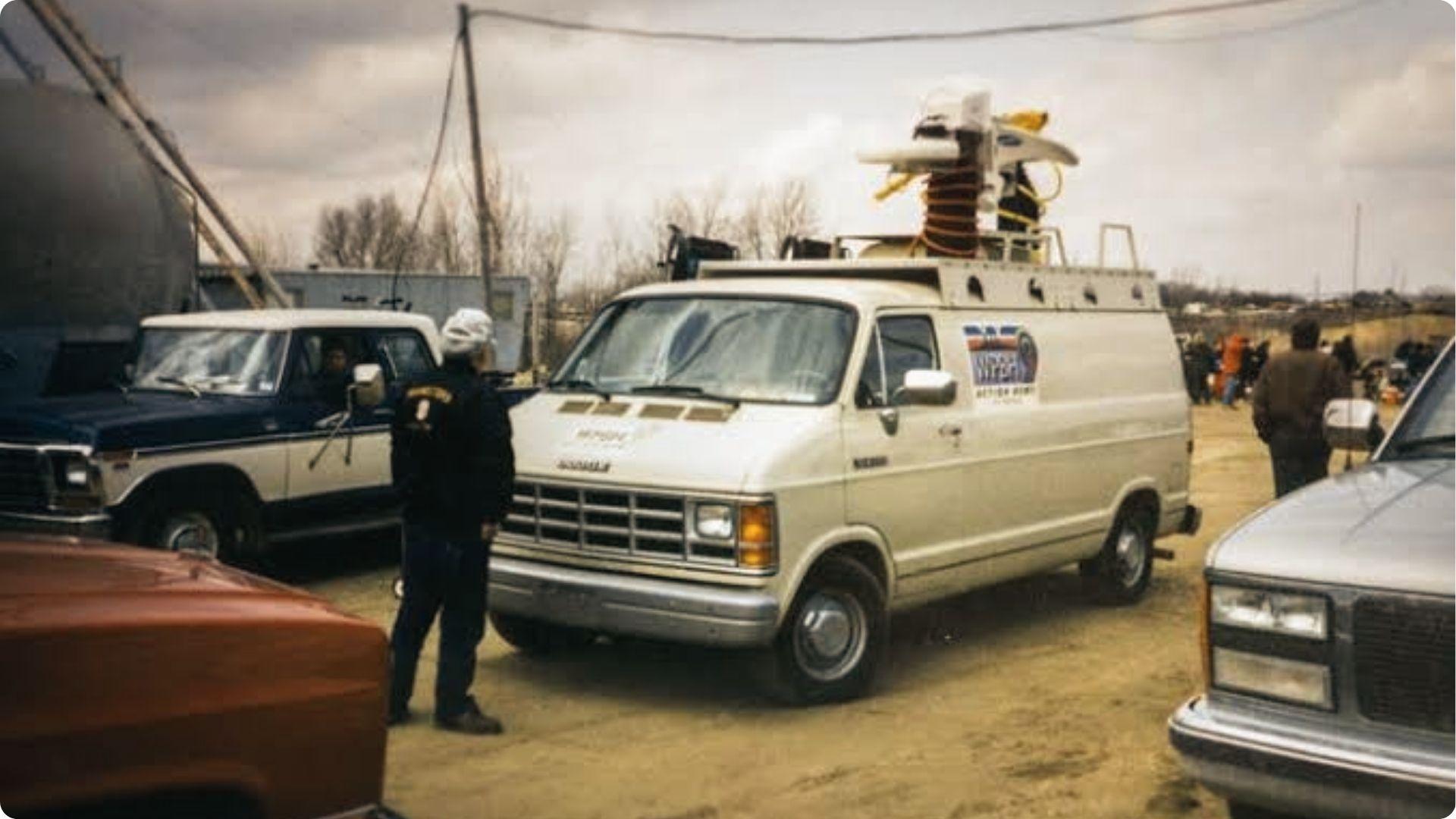 Vintage WPBN news van on set during Groundhog Day filming. Crew preps for Punxsutawney report.