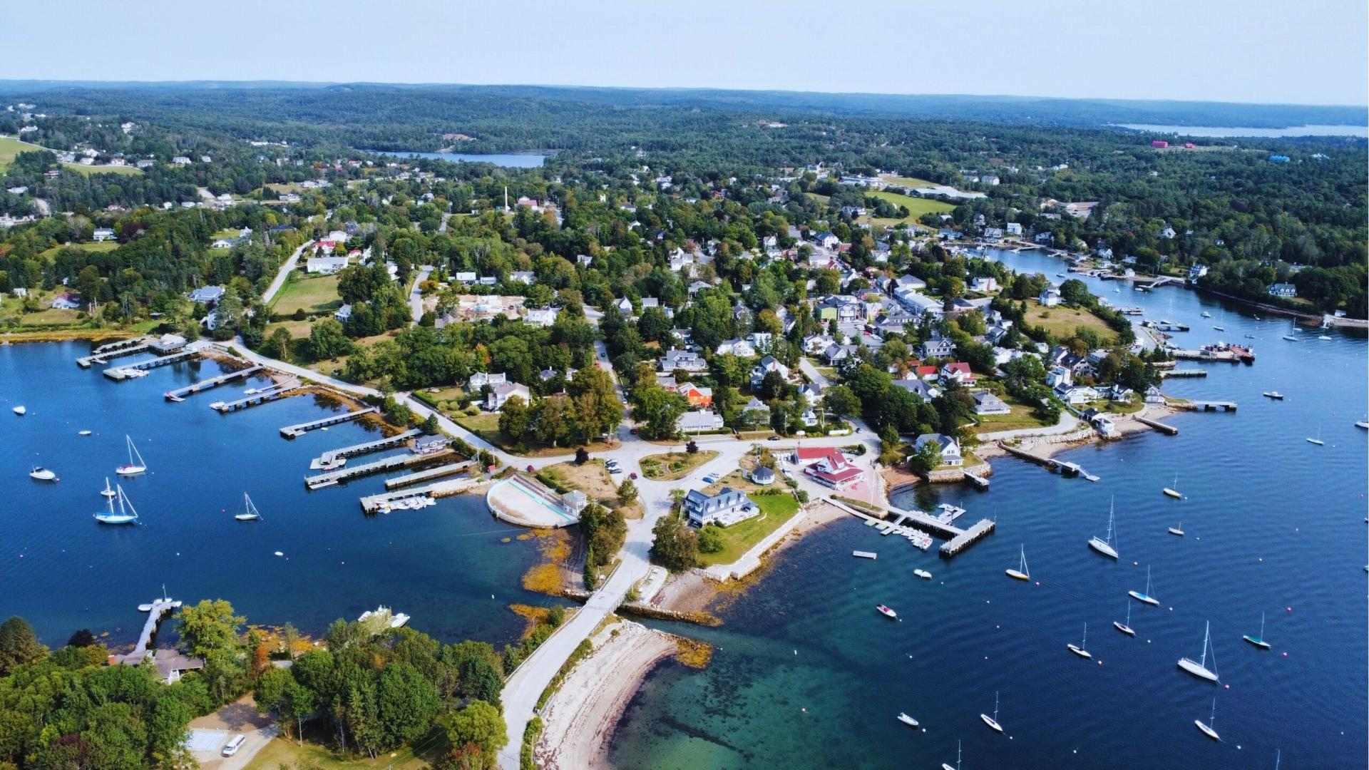Aerial of Chester, Nova Scotia village with docks and boats, used as We Were Liars Beechwood Island setting.